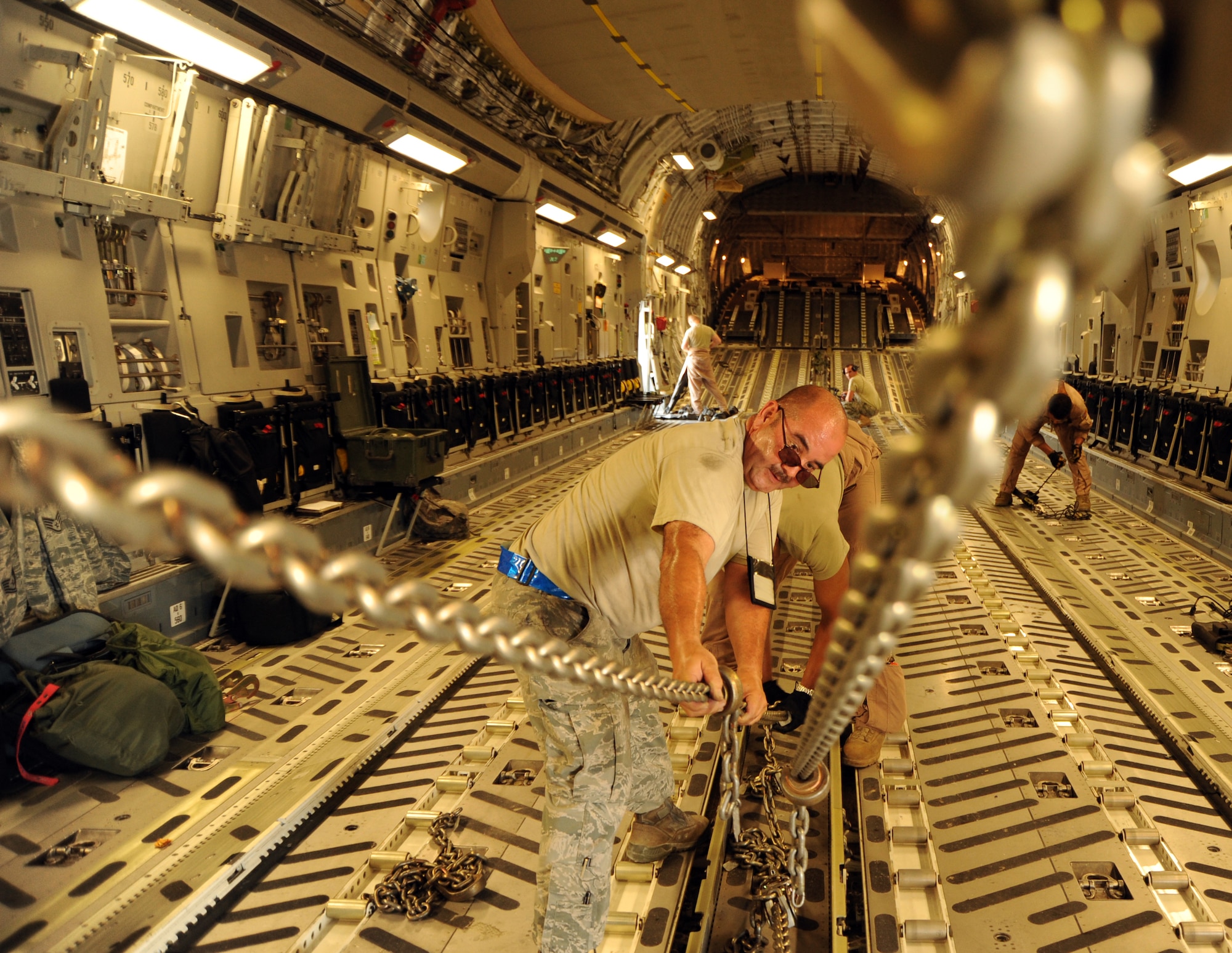 Tech. Sgt. Jose Gonzalez, 8th Expeditionary Air Mobility Squadron, assists in preparing a C-17 Globemaster III at an undisclosed location in Southwest Asia prior to an airdrop mission Aug. 13. (U.S. Air Force photo/Staff Sgt. Tim Jenkins)