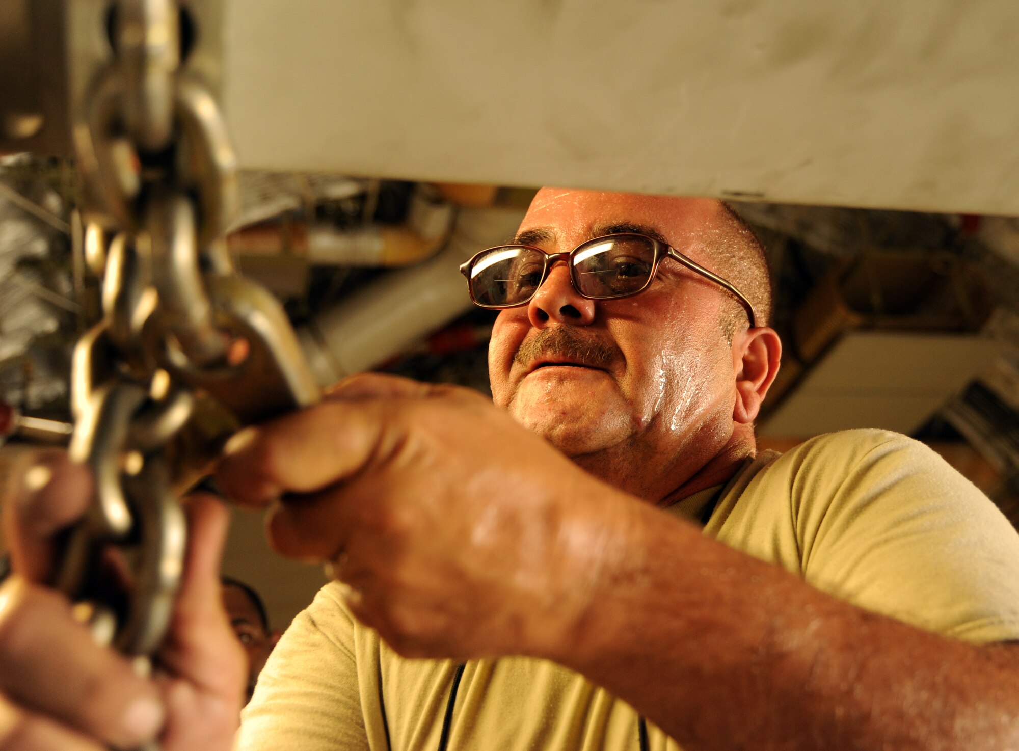 Tech. Sgt. Jose Gonzalez, 8th Expeditionary Air Mobility Squadron, assists in preparing a C-17 Globemaster III at an undisclosed location in Southwest Asia prior to an airdrop mission Aug. 13. (U.S. Air Force photo/Staff Sgt. Tim Jenkins)