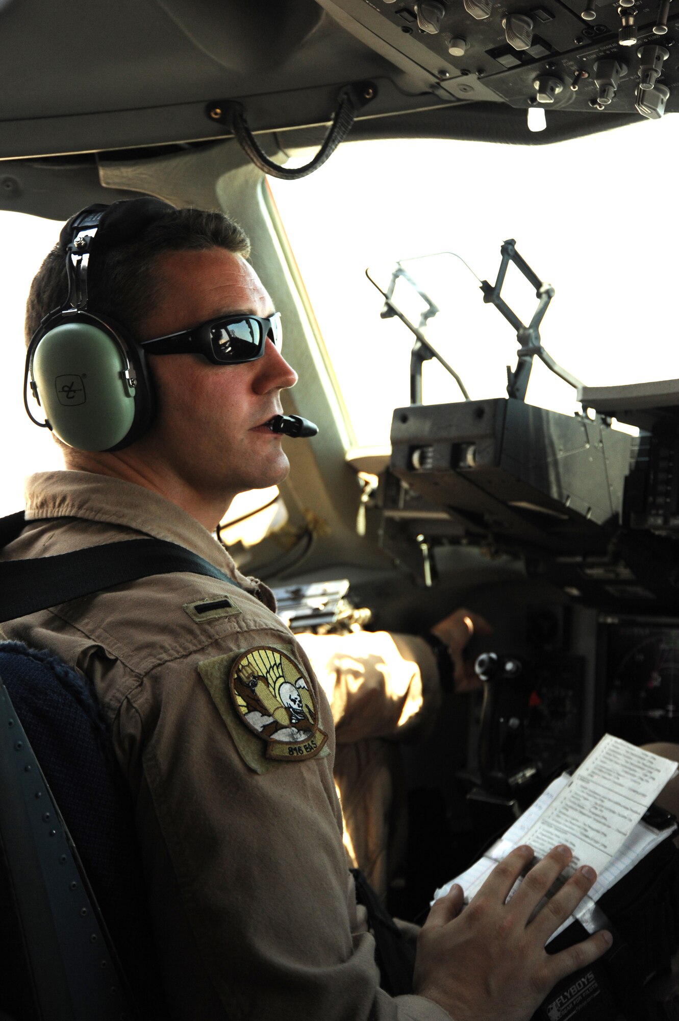 1st Lt. Daniel Hartung, 816th Expeditionary Airlift Squadron, conducts pre-flight checks in a C-17 Globemaster III at an undisclosed location in Southwest Asia prior to an airdrop mission Aug. 13. (U.S. Air Force photo/Staff Sgt. Tim Jenkins)