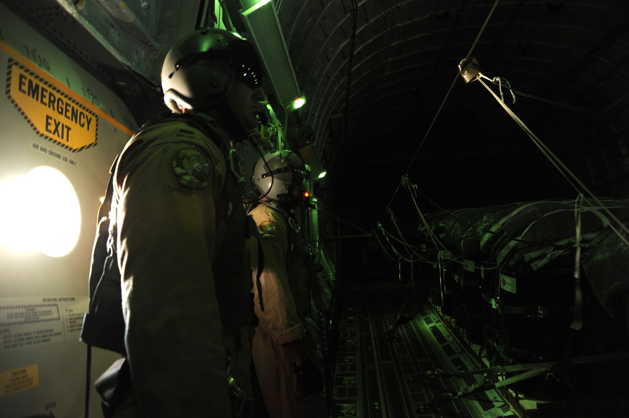 1st Lt. Daniel Hartung and Staff Sgt. Hardia Madden, 816th Expeditionary Airlift Squadron, wait for a C-17 rear door to open over the drop zone during an airdrop mission Aug. 13. (U.S. Air Force photo/Staff Sgt. Tim Jenkins)