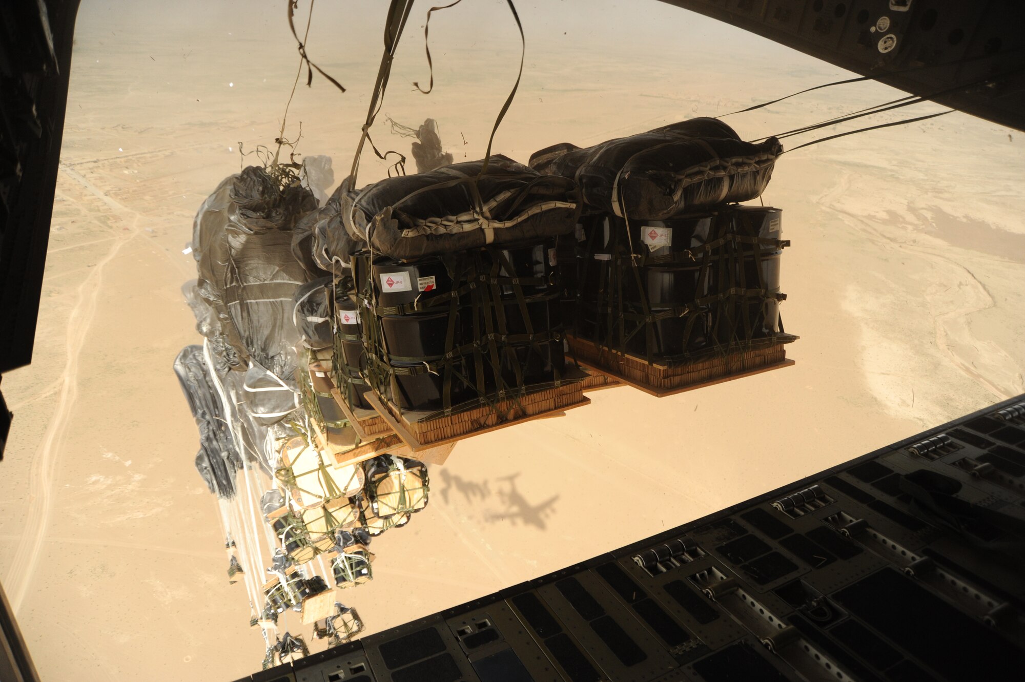 Fourty bundles of JP-8 fuel leave the back of a C-17 Globemaster III during an airdrop Aug. 13 by members of the 816th Expeditionary Airlift Squadron. The drop was part of Operation Everest, a week-long push to fully exercise the theater drop capability of the C-17, which resulted in 837 bundles delivered in one week. (U.S. Air Force photo/Staff Sgt. Tim Jenkins)