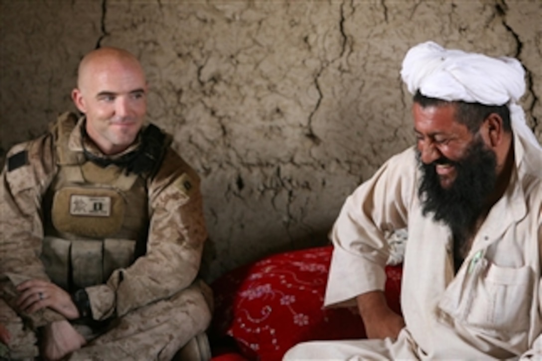U.S. Marine Corps Capt. Sean Barnes (left) with 3rd Battalion, 1st Marine Regiment, Regimental Combat Team 7 listens as an Afghan National Army commander (right) talks during a patrol near Patrol Base Koshtay, Afghanistan, on Aug. 7, 2010.  U.S. Marines and Afghan National Army soldiers conducted security patrols to talk with Afghan residents.  
