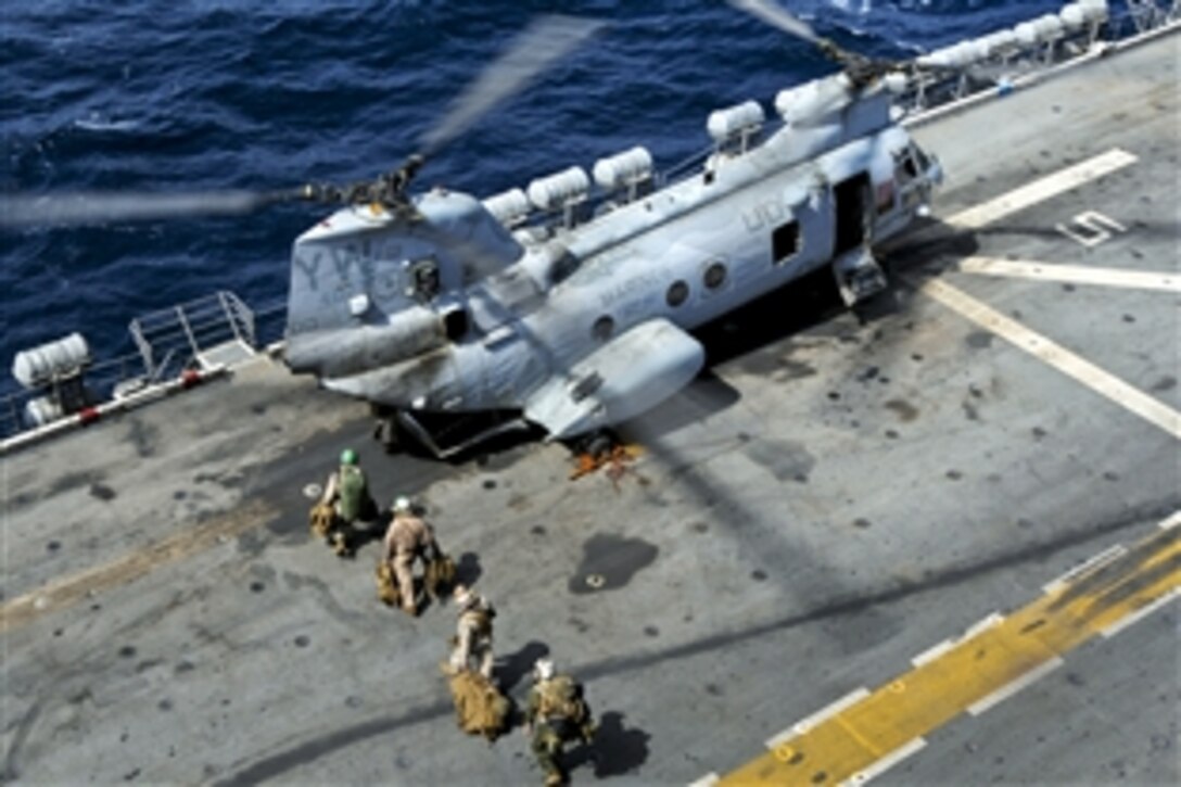 U.S. Marines embark a Marine Corps CH-46 Sea Knight aboard amphibious assault ship USS Peleliu in the North Arabian Sea, Aug. 18, 2010. The Marines and the helicopter will join the 11 other helicopters from Peleliu already on station in northern Pakistan. The Peleliu Amphibious Ready Group is supporting the Pakistani government with helicopter heavy lift capabilities in flooded regions of Pakistan.
