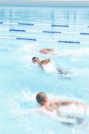 Competitors race 50 meters to answer one of the trivia questions during the Commander’s Cup Aqua Fitness Feud at the water works outdoor pool here Aug. 20. The purpose of the competition was to test endurance and knowledge.