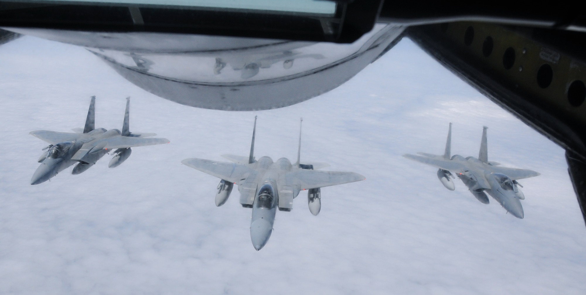 F-15s from the Hawaii Air National Guard fly in formation after an aerial refueling mission over the Pacific Ocean, August 18, 2010. The photo was taken from the boom operator?s position of a KC-135 from the 161st Air Refueling Wing. (U.S. Air Force Photo by Senior Airman Nicole Enos)
