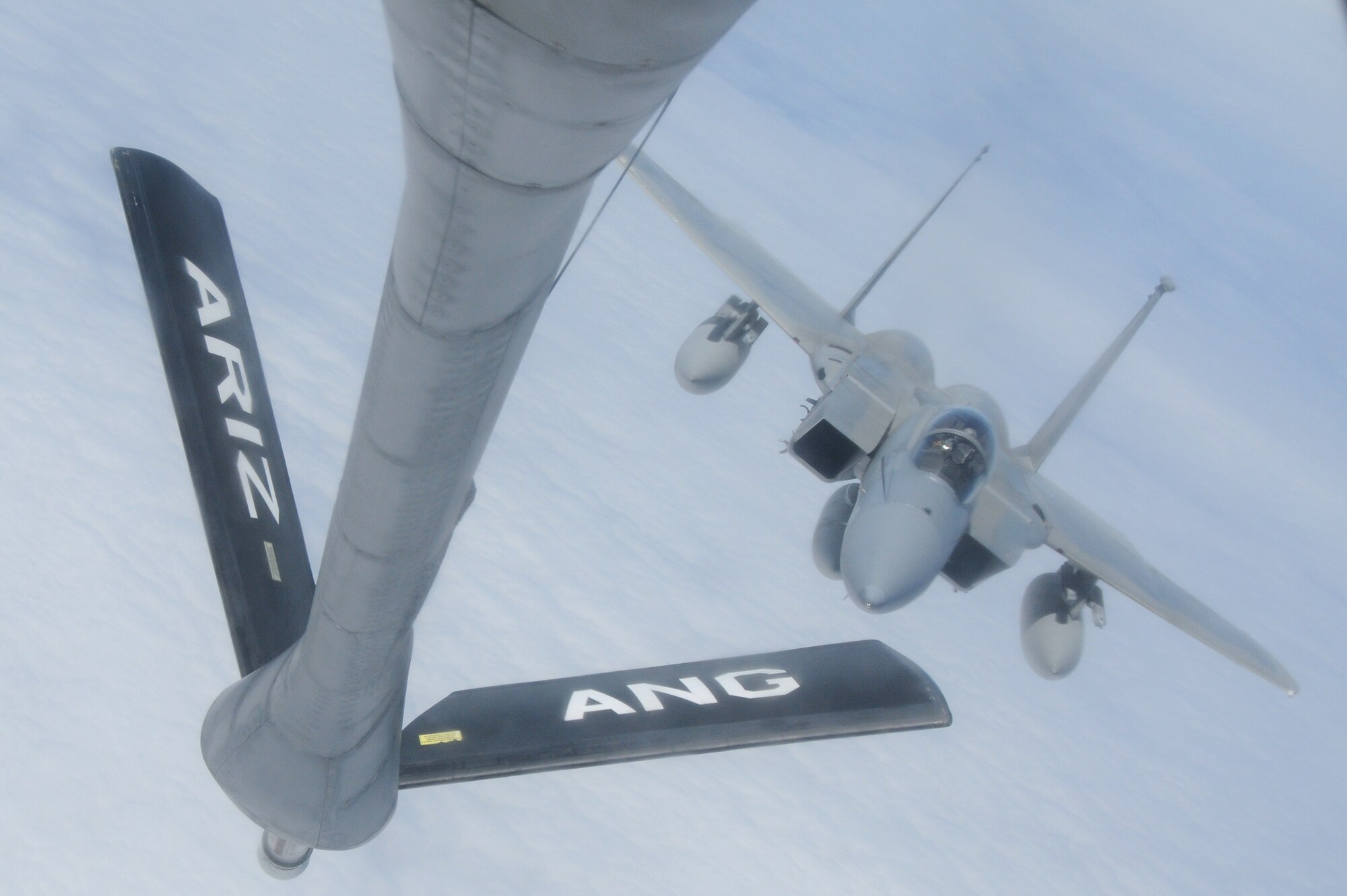A KC-135 from the 161st Air Refueling Wing prepares to refuel an F-15 from the Hawaii Air National Guard during an aerial refueling mission over the Pacific Ocean, August 18, 2010. The KC-135 refueled three F-15s on their way to Nellis Air Force Base. (U.S. Air Force Photo by Senior Airman Nicole Enos)

