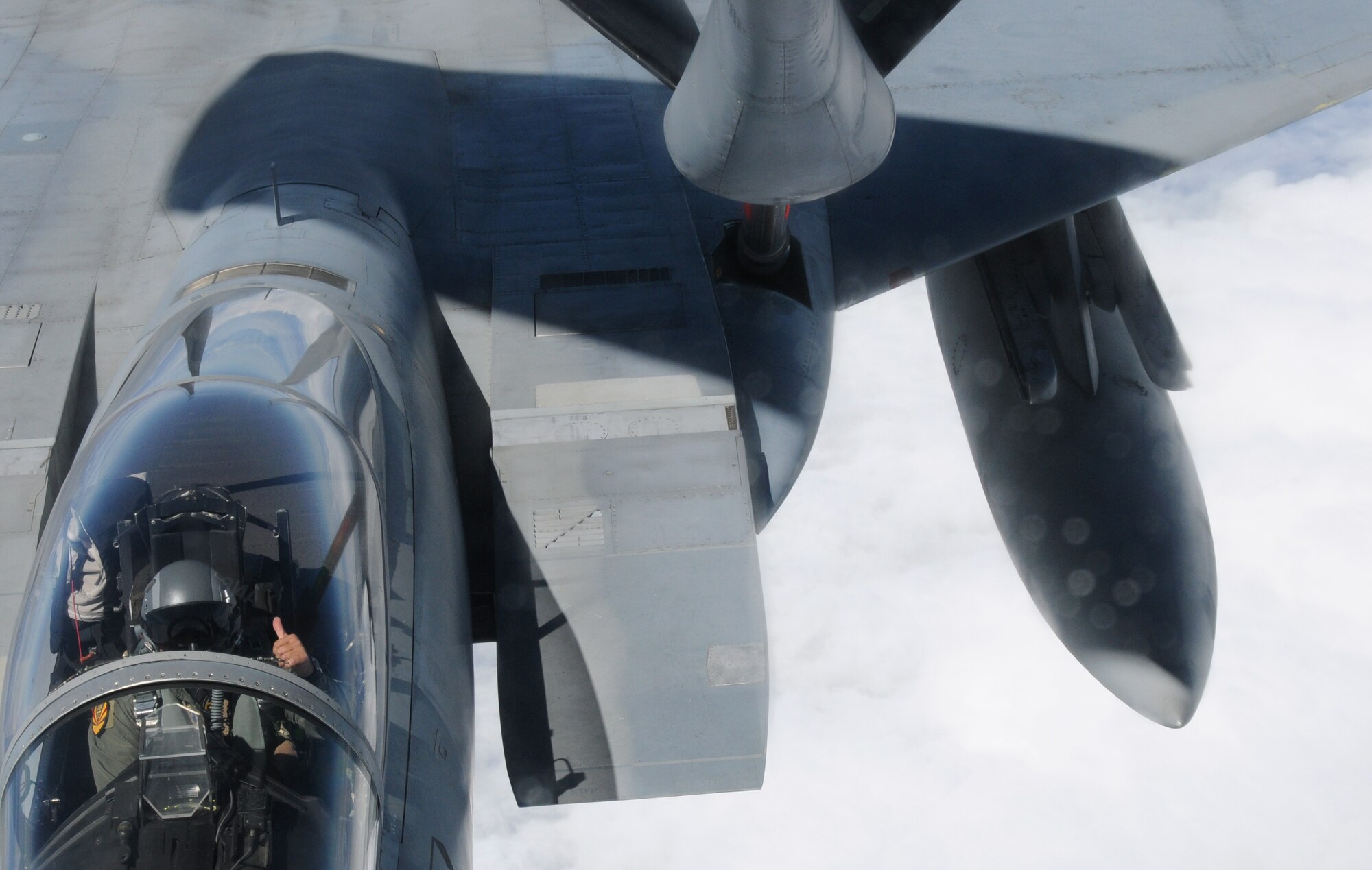 A KC-135 from the 161st Air Refueling Wing refuels an F-15 from the Hawaii Air National Guard during an aerial refueling mission over the Pacific Ocean, August 18, 2010. The fighter pilot thanks the boom operator by flashing him a hang-ten when the air refueling is complete. (U.S. Air Force Photo by Senior Airman Nicole Enos)

