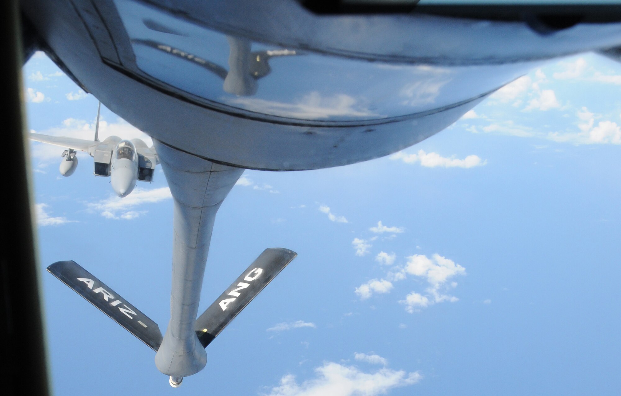 A KC-135 from the 161st Air Refueling Wing prepares to refuel an F-15 from the Hawaii Air National Guard during an aerial refueling mission over the Pacific Ocean, August 18, 2010. The KC-135 refueled three F-15s on their way to Nellis Air Force Base. (U.S. Air Force Photo by Senior Airman Nicole Enos)
