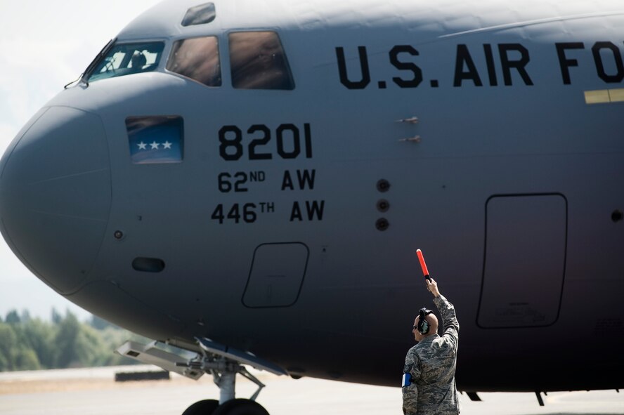 Tech. Sgt. Edward Callahan, assigned to the 446th Aircraft Maintenance Squadron, marshals McChord Field's newest C-17 Globemaster III Aug. 20 Joint Base Lewis-McChord, Wash. (U.S. Air Force Photo/Abner Guzman)