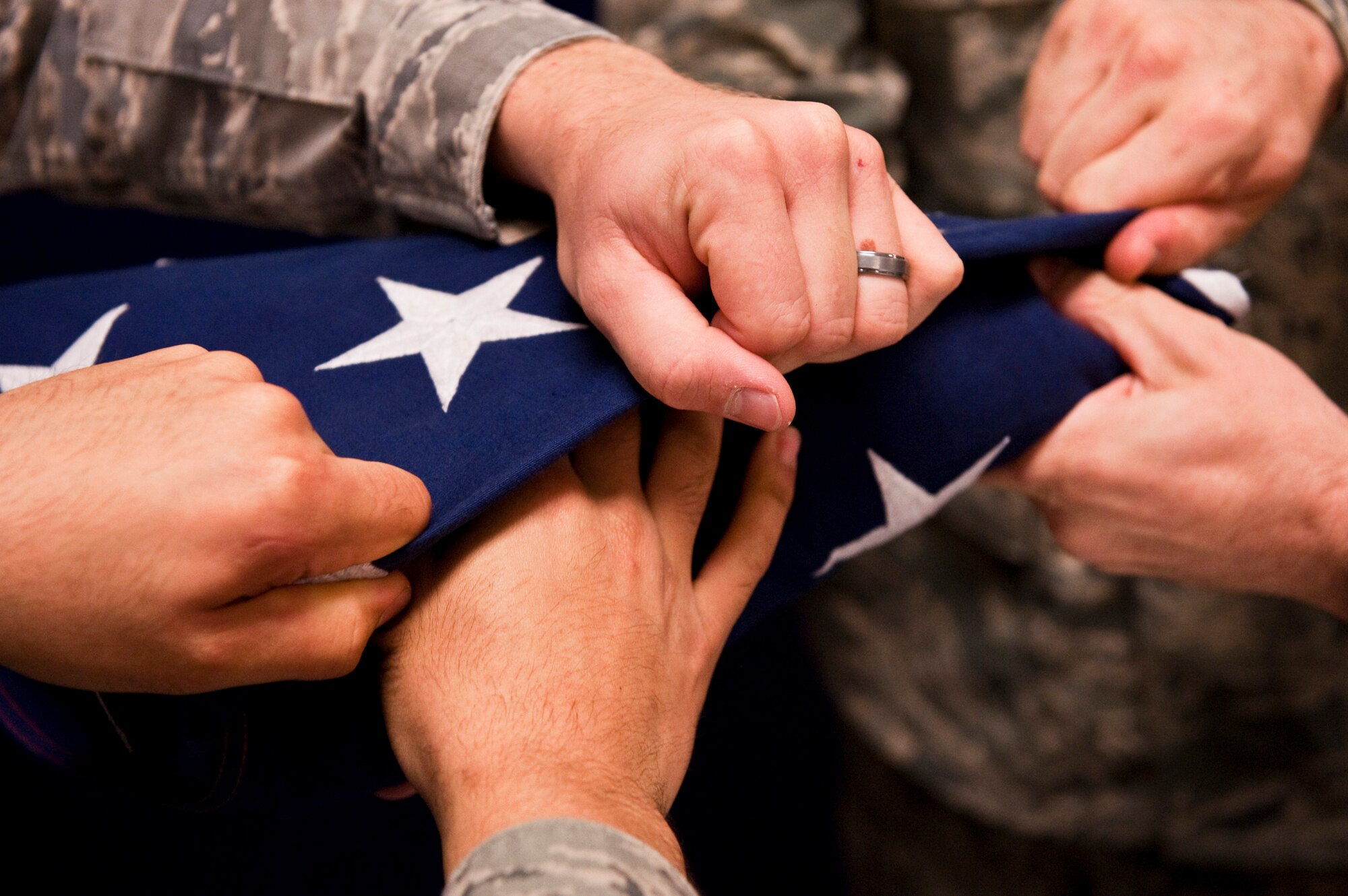 JOINT BASE ELMENDORF-RICHARDSON, Alaska -- Member of Joint Base Elmendorf-Richardson's honor guard fold the flag during a practice Aug. 19. (Photo by Airman 1st Class Christopher Gross/JBER PAO)