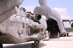 A CH-53E Super Stallion helicopter with the 26th Marine Expeditionary Unit is loaded onto an Air Force C-17 Globemaster III aircraft at Marine Corps Air Station Cherry Point, N.C., Aug. 20. The C-17, from Joint Base Charleston, S.C., will carry the CH-53E, one of four for the 26th MEU, to Pakistan to aid in the MEU’s relief operations in the flood-ravaged region. (U.S. Marine Corps photo/Lance Cpl. Brian Jones) 