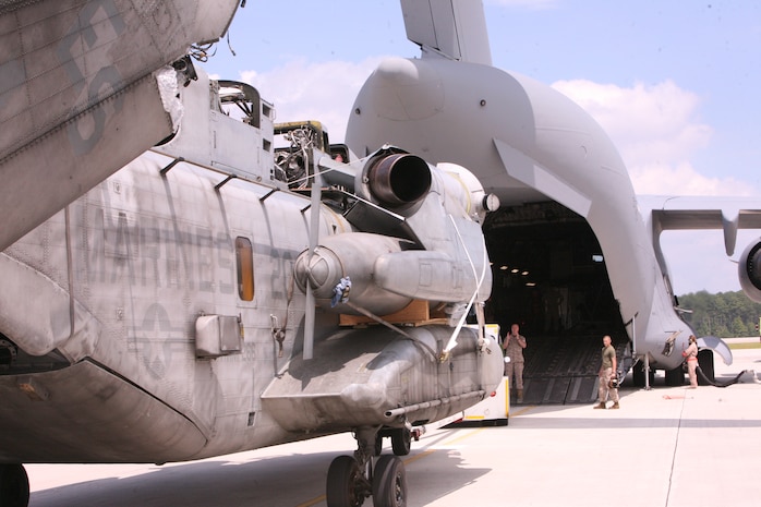 A CH-53E Super Stallion helicopter with the 26th Marine Expeditionary Unit is loaded onto an Air Force C-17 Globemaster III aircraft at Marine Corps Air Station Cherry Point, N.C., Aug. 20. The C-17, from Joint Base Charleston, S.C., will carry the CH-53E, one of four for the 26th MEU, to Pakistan to aid in the MEU’s relief operations in the flood-ravaged region. (U.S. Marine Corps photo/Lance Cpl. Brian Jones) 