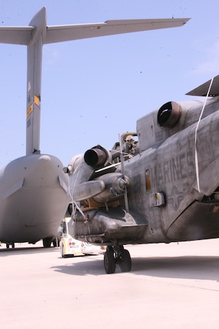 Marines deploying with the 26th Marine Expeditionary Unit load a CH-53E Super Stallion helicopter onto a Charleston based C-17 Globemaster III aircraft at Marine Corps Air Station Cherry Point, N.C., Aug. 20. The C-17 will take the Marines and their aircraft to Pakistan to aid in humanitarian operations for a region recently ravaged by floods. (U.S. Marine Corps photo/Lance Cpl. Brian Jones)