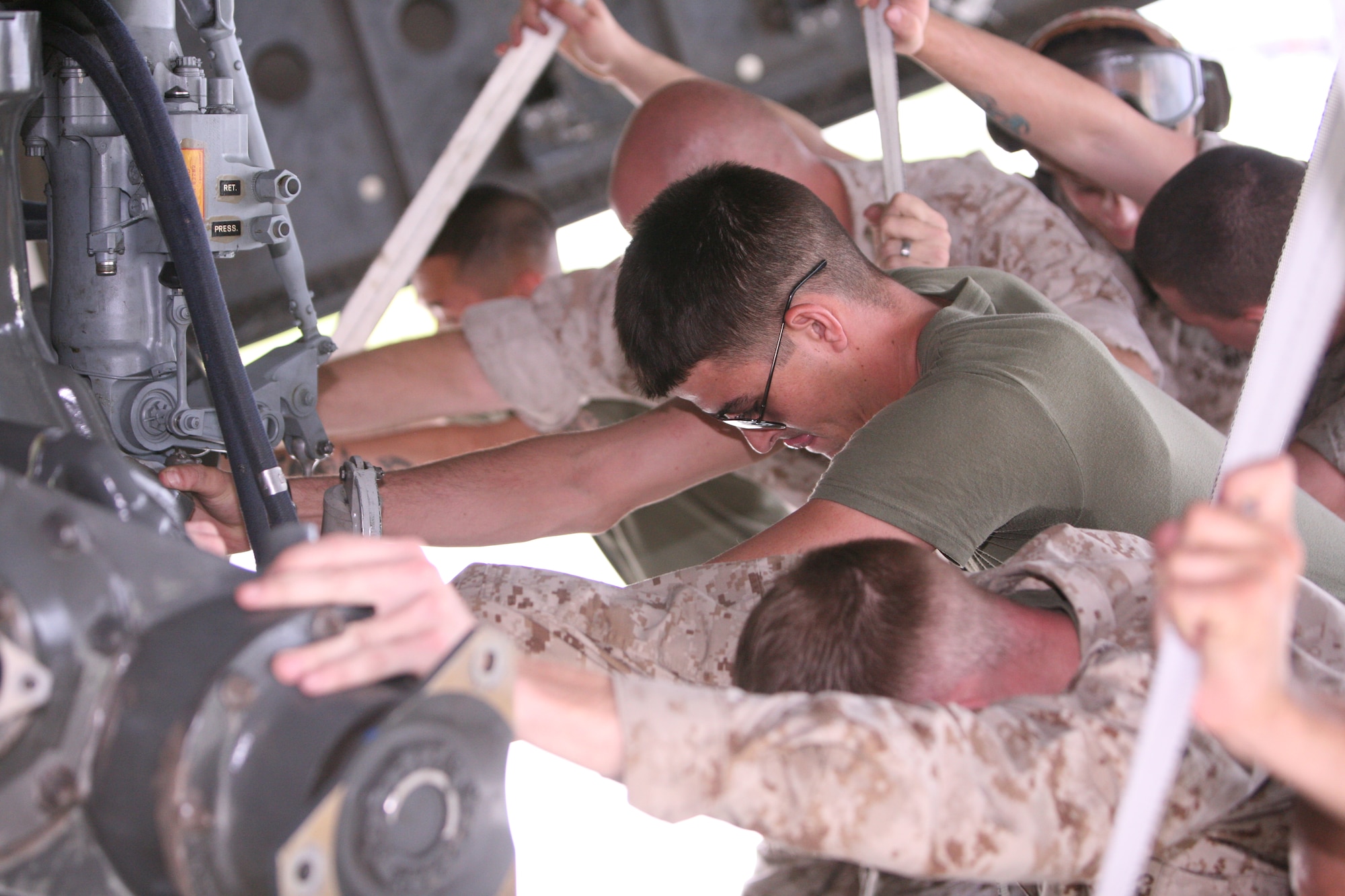 Sgt. Leo R. Parry II pushes the engine of a CH-53E Super Stallion helicopter into the hull of a Charleston based C-17 at Marine Corps Air Station Cherry Point, N.C., Aug. 20. Parry is a crew chief for the CH-53Es. The helicopter is one of four being transported by the 437th Airlift Wing to Pakistan for the 26th Marine Expeditionary Unit, which will conduct humanitarian operations in the area. (U.S. Marine Corps photo/Lance Cpl. Brian Adam Jones)