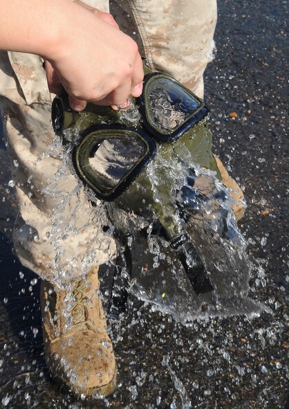 BARKSDALE AIR FORCE BASE, La -- A gas mask belonging to a Marine from 1st Battalion 23rd Marines in Bossier City, gets rinsed off after chemical warfare training Aug. 14. More than 120 Marines went through the gas chamber, provided by 2d Civil Engineer Squadron emergency management, as annual training prior to a deployment. Though the mask is worn into the chamber, members were required to take it off and answer a question asked by the instructors as the tear gas was being released. (U.S. Air Force photo/Senior Airman Amber Ashcraft) (RELEASED)