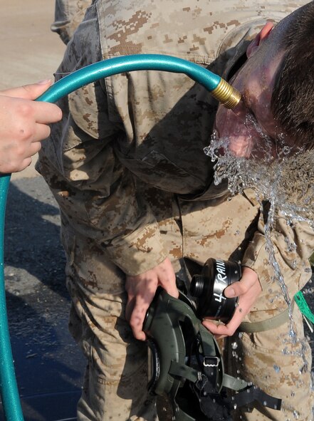 BARKSDALE AIR FORCE BASE, La -- A Marine from 1st Battalion 23rd Marines in Bossier City, gets his face rinsed off after chemical warfare training Aug. 14. More than 120 Marines went through the gas chamber, provided by 2d Civil Engineer Squadron emergency management, as annual training prior to a deployment. Though the mask is worn into the chamber, members were required to take it off and answer a question asked by the instructors as the tear gas was being released. (U.S. Air Force photo/Senior Airman Amber Ashcraft) (RELEASED)