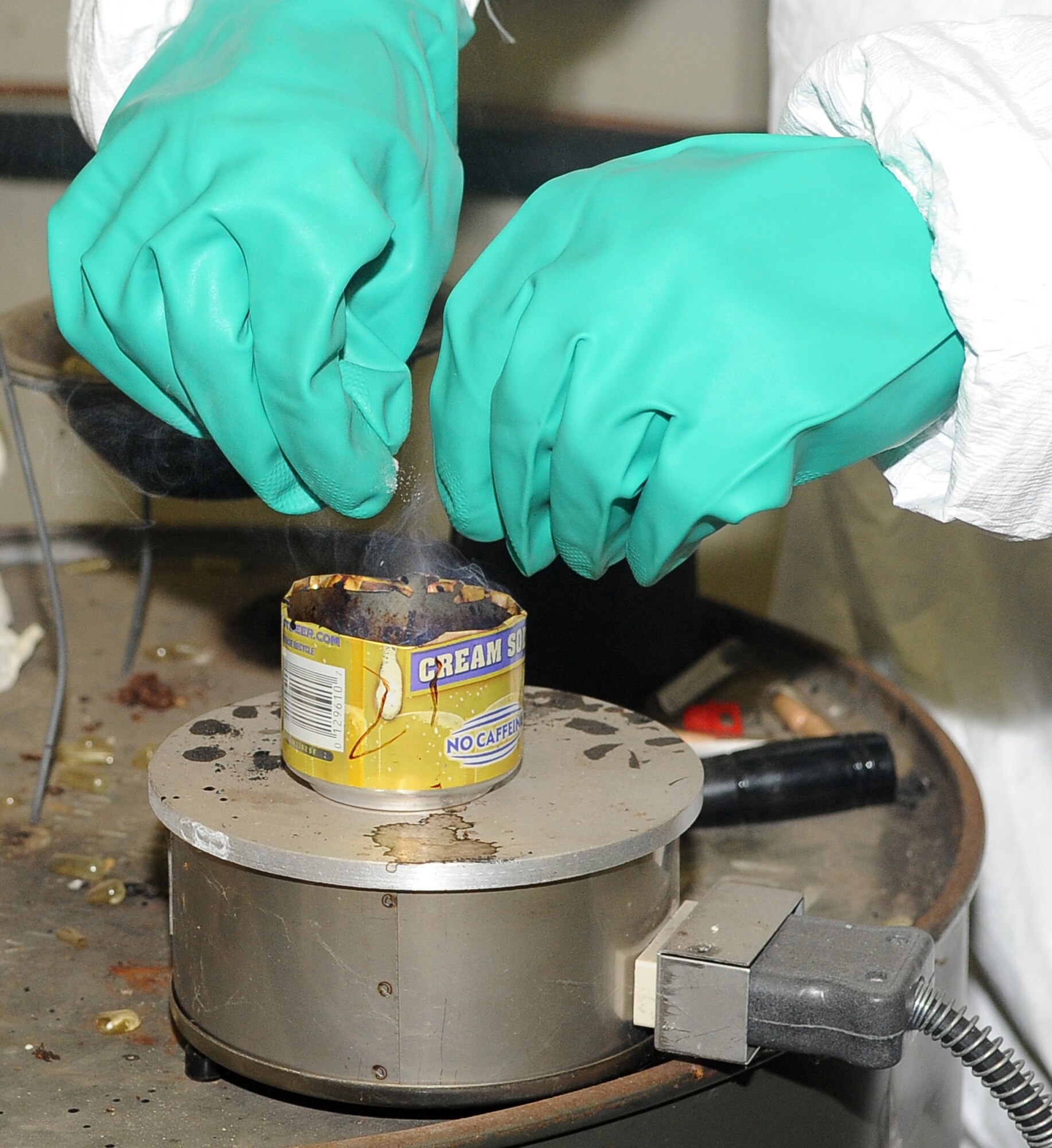 BARKSDALE AIR FORCE BASE, La -- Staff Sgt. Patrick McGarvey, 2d Civil Engineer Squadron emergency management, breaks more tear gas capsules during chemical warfare training Aug. 14. More than 120 Marines from 1st Battalion 23rd Marines in Bossier City went through the gas chamber, provided by 2d CES, as an annual training prior to a deployment. Though the mask is worn into the chamber, members were required to take it off and answer a question asked by the instructors as the tear gas was being released. (U.S. Air Force photo/Senior Airman Amber Ashcraft) (RELEASED)