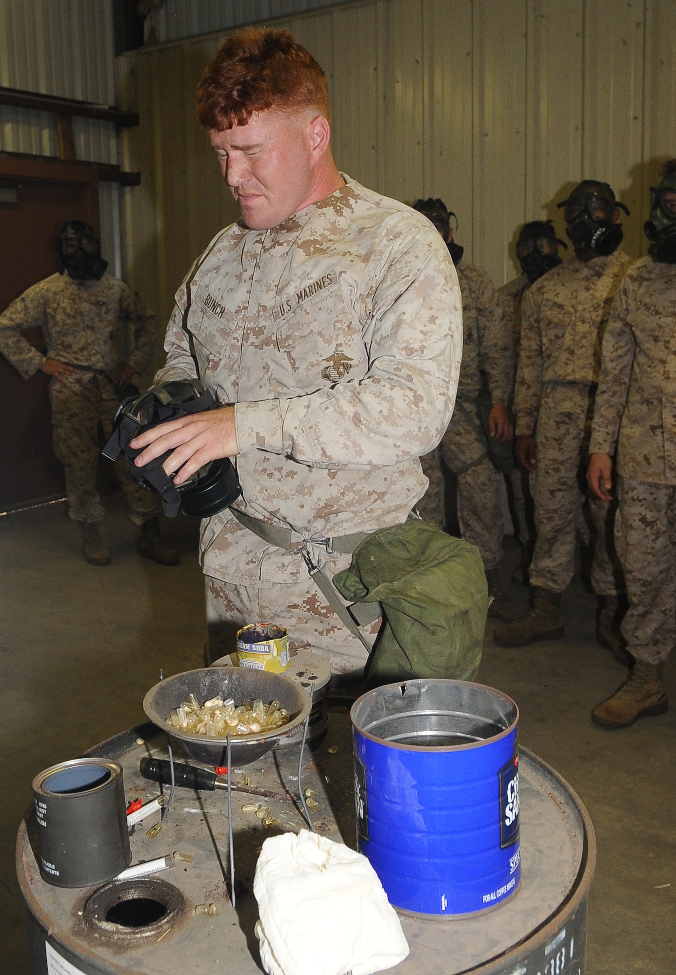 BARKSDALE AIR FORCE BASE, La -- A Marine from 1st Battalion 23rd Marines in Bossier City, experiences the tear gas during chemical warfare training Aug. 14. More than 120 Marines went through the gas chamber, provided by 2d Civil Engineer Squadron emergency management, as an annual training prior to a deployment. Though the mask is worn into the chamber, members were required to take it off and answer a question asked by the instructors as the tear gas was being released. (U.S. Air Force photo/Senior Airman Amber Ashcraft) (RELEASED)