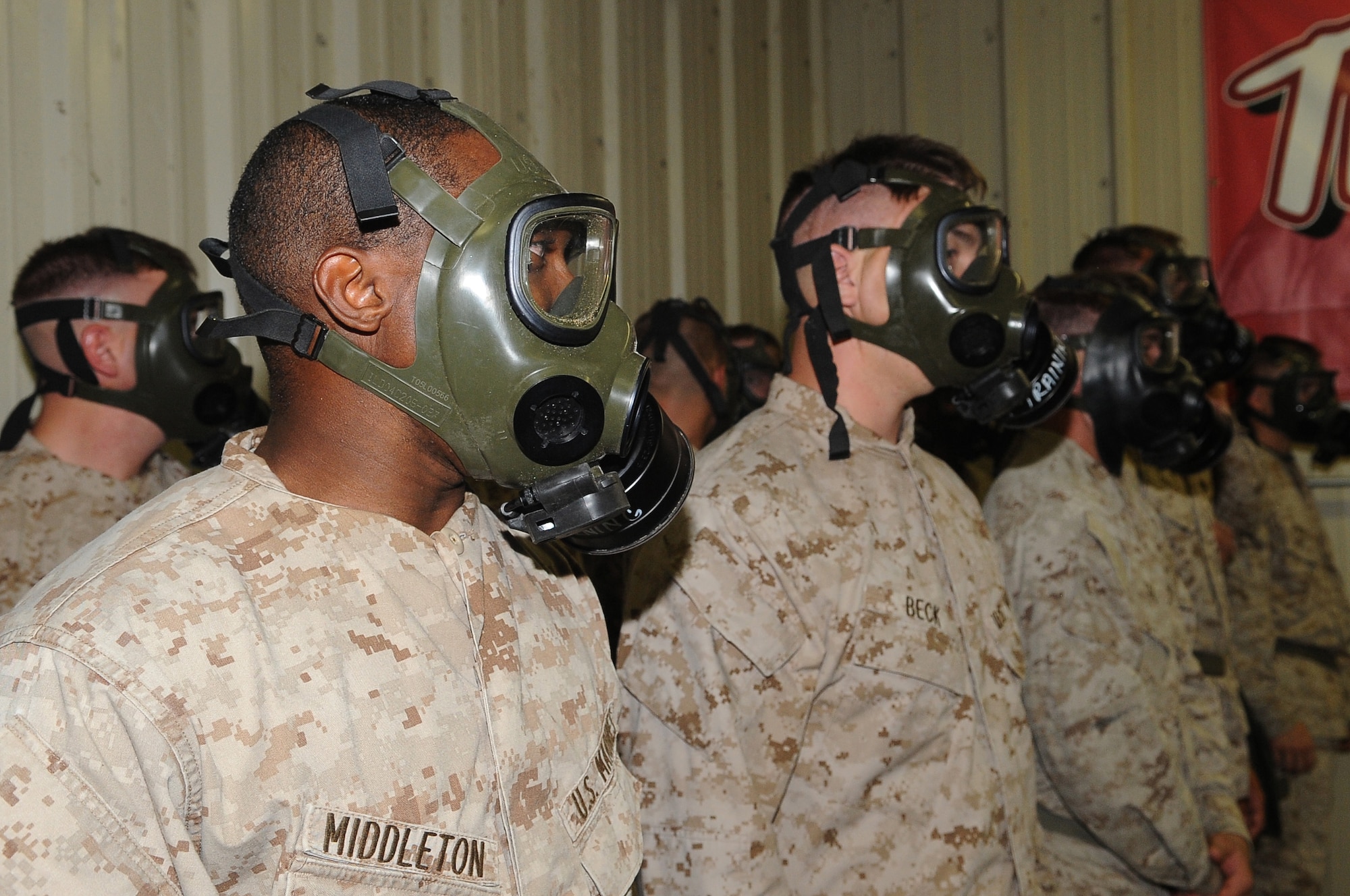 BARKSDALE AIR FORCE BASE, La -- Marines from 1st Battalion 23rd Marines in Bossier City, wait for instruction during chemical warfare training Aug. 14. More than 120 Marines went through the gas chamber, provided by 2d Civil Engineer Squadron emergency management, as annual training prior to a deployment. Though the mask is worn into the chamber, members were required to take it off and answer a question asked by the instructors as the tear gas was being released. (U.S. Air Force photo/Senior Airman Amber Ashcraft) (RELEASED)