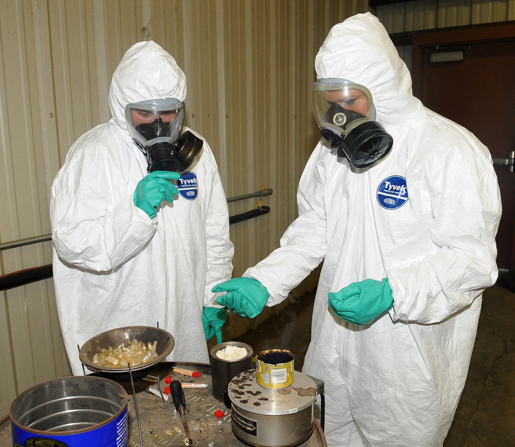BARKSDALE AIR FORCE BASE, La -- (Left to right) Senior Airman Laura Heineman and Airman 1st Class Nika Kliebert, 2d Civil Engineer Squadron emergency management, make sure the tear gas is being released properly during chemical warfare training Aug. 14. More than 120 Marines from 1st Battalion 23rd Marines in Bossier City went through the gas chamber, provided by 2d CES, as annual training prior to a deployment. Though the mask is worn into the chamber, members were required to take it off and answer a question asked by the instructors, as the tear gas was being released. (U.S. Air Force photo/Senior Airman Amber Ashcraft) (RELEASED)