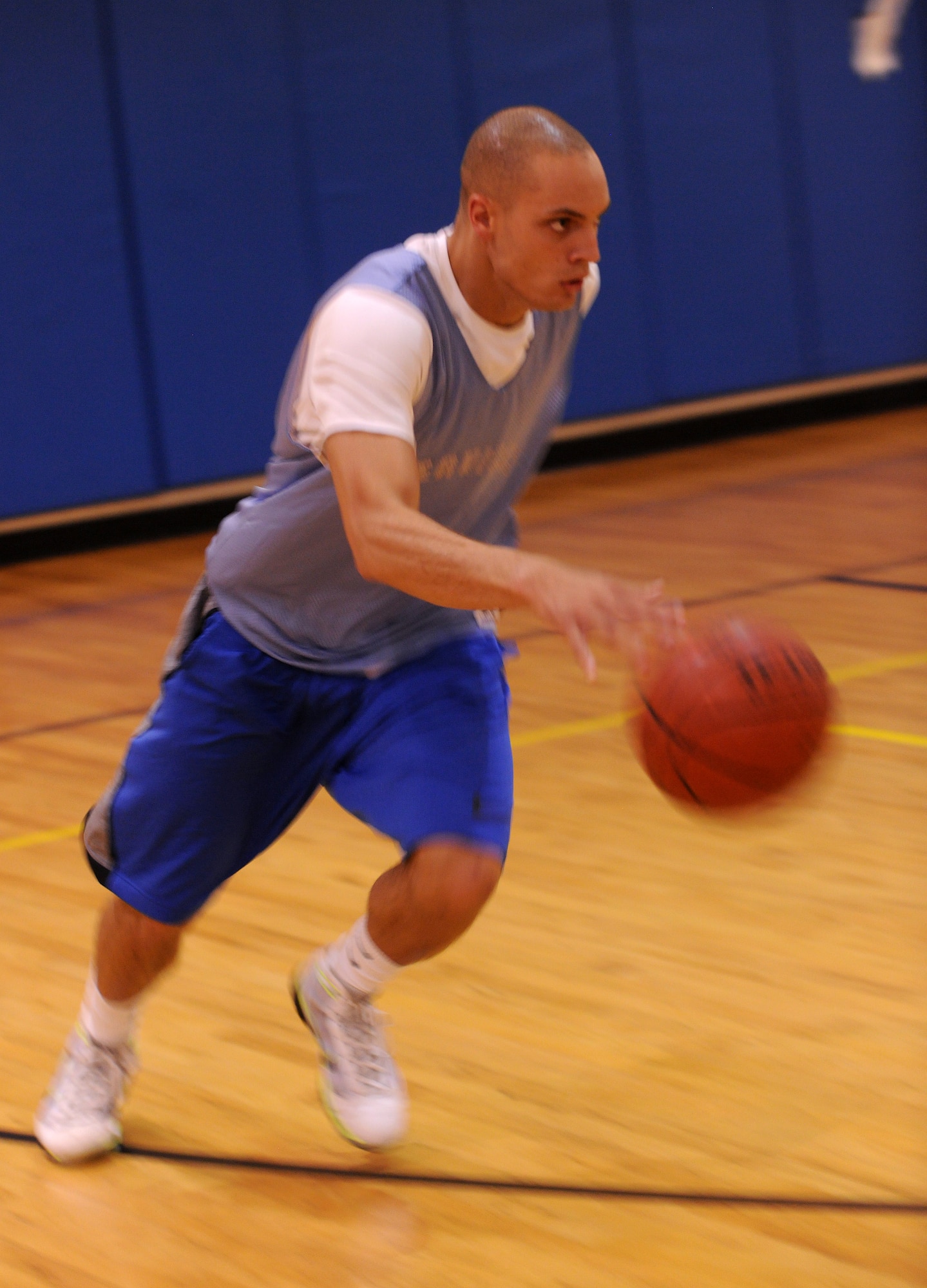 MOODY AIR FORCE BASE, Ga. --Airman 1st Class Mathew Alexander, 23 Communications Squadron network infrastructures, pushes the ball up the court during a game of basketball during varsity basketball team tryouts here Aug. 18. Players were split into three teams and played full court games for a large portion of the tryout. (U.S. Air Force photo by Airman 1st Class Benjamin Wiseman/RELEASED)
