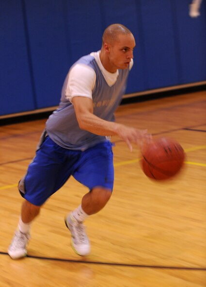 MOODY AIR FORCE BASE, Ga. --Airman 1st Class Mathew Alexander, 23 Communications Squadron network infrastructures, pushes the ball up the court during a game of basketball during varsity basketball team tryouts here Aug. 18. Players were split into three teams and played full court games for a large portion of the tryout. (U.S. Air Force photo by Airman 1st Class Benjamin Wiseman/RELEASED)
