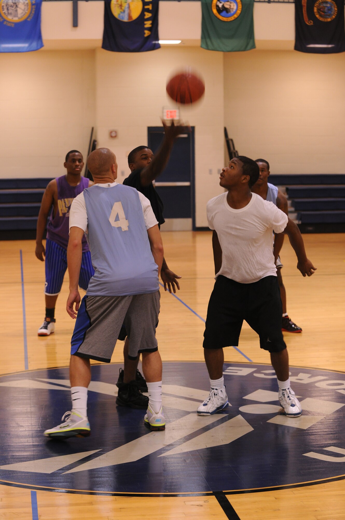 MOODY AIR FORCE BASE, Ga. --Airman 1st Class Mathew Alexander, 23rd Communications Squadron network infrastructures, and Airman 1st Class Derico English, 723rd Aircraft Maintenance Squadron electrical and environmental, jump for the ball at the beginning of a basketball game played during varsity basketball team tryouts. Toward the end of tryouts, players were divided into teams and games were played so the tryout hopefuls could have one last shot to impress the coaches. (U.S. Air Force photo by Airman 1st Class Benjamin Wiseman/RELEASED)
