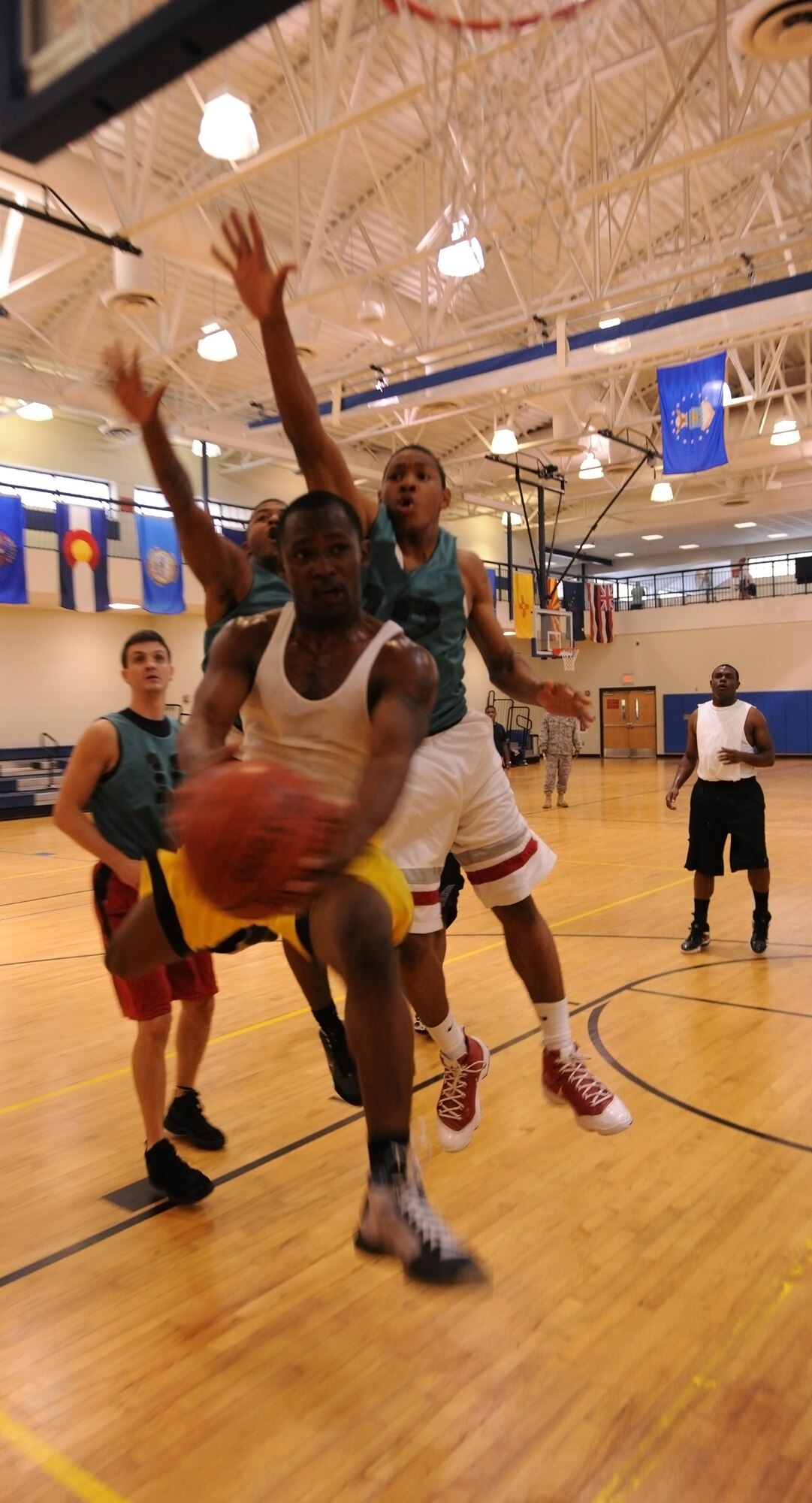 MOODY AIR FORCE BASE, Ga. -- Senior Airman William Nelson, 23rd Security Forces Squadron, lays the ball up under the block of two defenders during varsity basketball tryouts here Aug. 18. Airmen from Moody were invited out to show their skills to become a member of the Moody Varsity Basketball team. (U.S. Air Force photo by Airman 1st Class Benjamin Wiseman/RELEASED)
