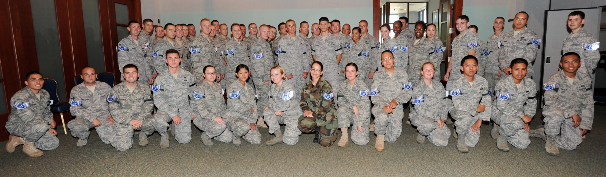 Team McConnell Staff Sgt. selects pose for a photo after receiving the news of their promotion Aug. 19, 2010, McConnell Air Force Base, Kan. Out of the 13,518 selected 132 McConnell members were selected. (U.S. Air Force photo/Airman 1st Class Andrea Salazar)