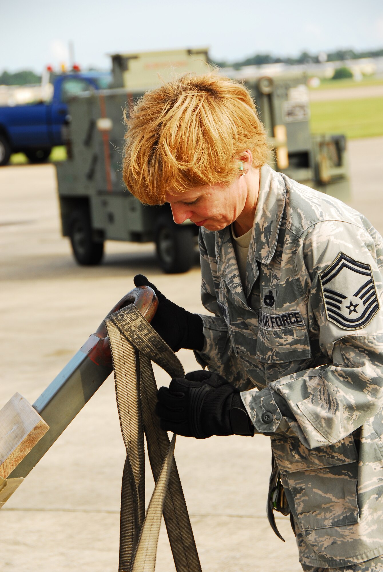 Senior Master Sgt. Mary Adamson, 41st Aerial Port Squadron, Keesler Air Force Base, Miss., ties a strap onto cargo being loaded into a C-5 Galaxy from the 68th Airlift Squadron, 433rd Airlift Wing, Kelly Field Annex, Texas, in support of joint-operation Impact of Typhoons on the Ocean in the Pacific. The Guam-bound plane delivers cargo to participating 53rd Weather Reconnaissance Squadron Reservists for use in ITOP missions. (U.S. Air Force Photo by Senior Airman Tabitha Dupas)