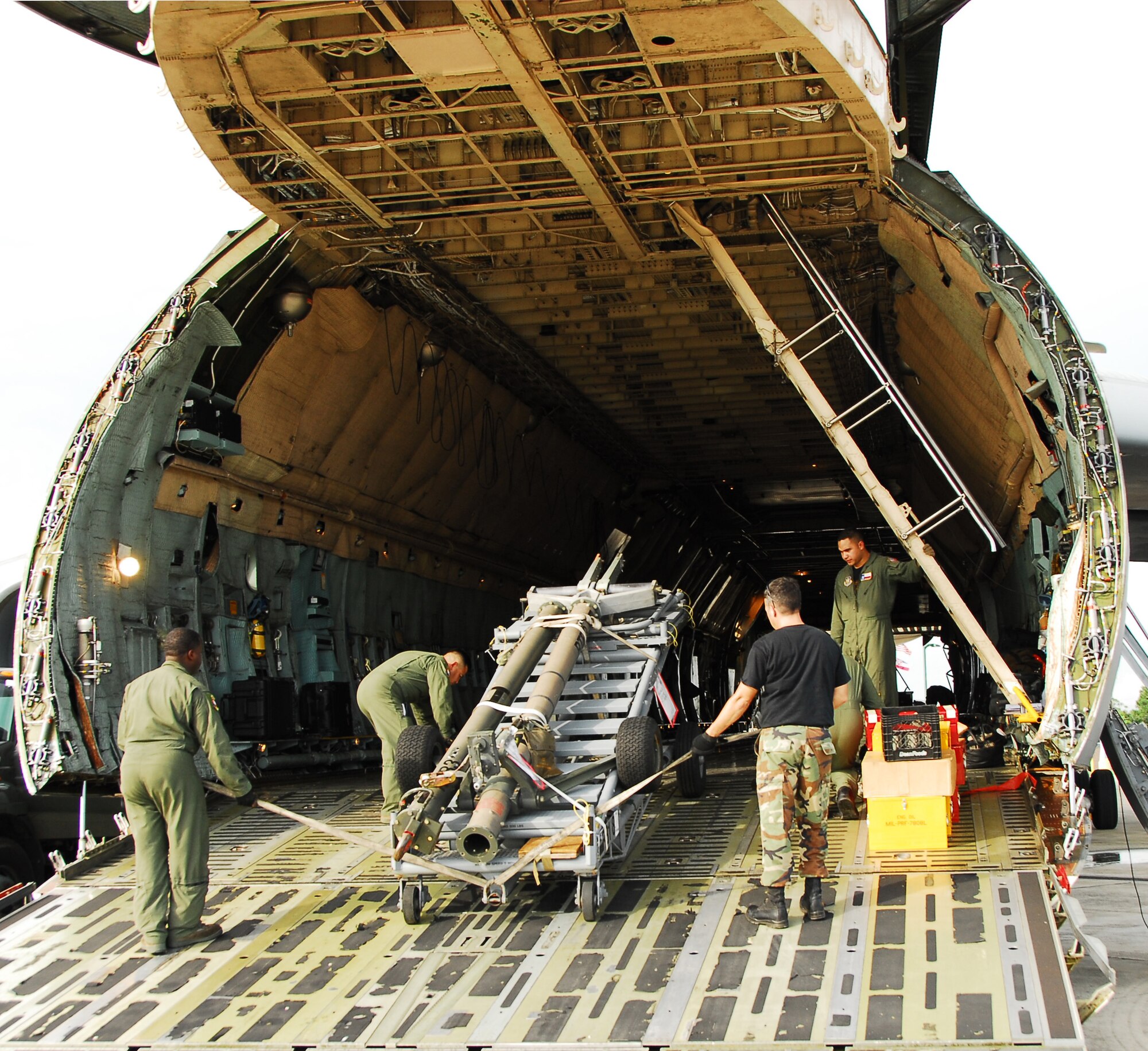 Reservists from the 403rd Wing, Keesler Air Force Base, Miss., and 68th Airlift Squadron, 433rd Airlift Wing, Kelly Field Annex, Texas, load cargo into a C-5 Galaxy in support of joint-operation Impact of Typhoons on the Ocean in the Pacific. The Guam-bound plane delivers cargo to participating 53rd Weather Reconnaissance Squadron Reservists for use in ITOP missions. (U.S. Air Force Photo by Senior Airman Tabitha Dupas)