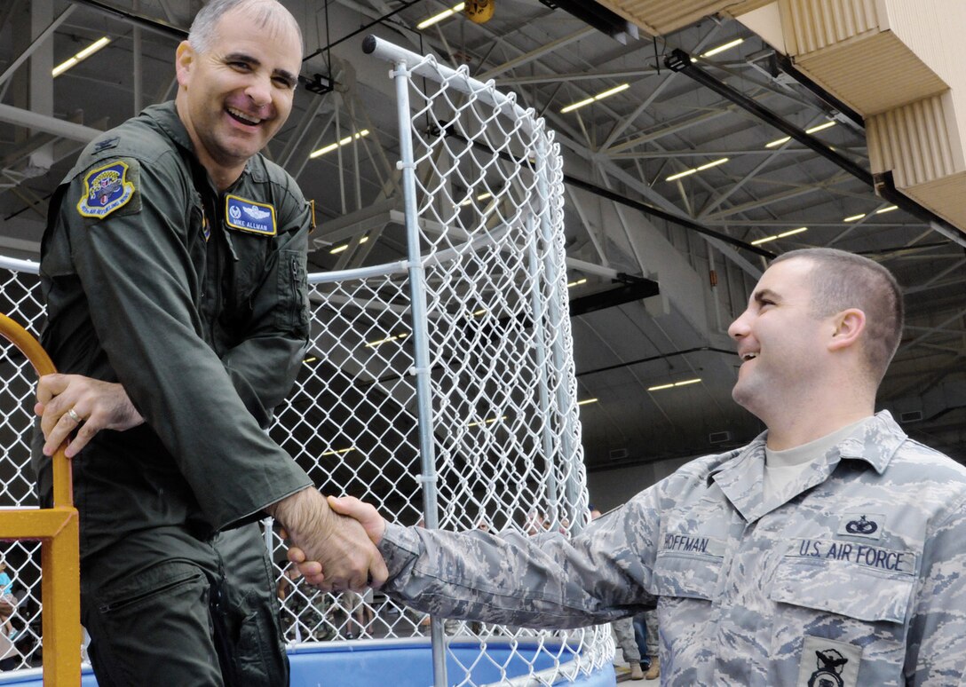 Colonel James M. Allman, 459th Air Refueling Wing commander, congratulates Staff Sgt. Cory Hoffman, 459th Security Forces Squadron, for a successful dunking during the 2010 Family Day event Aug. 14. Airmen from the 459 ARW joined their spouses and children for the 2010 Family Day event, which provided an afternoon full of activities, a tour of a KC-135R Stratotanker, food and music. The event also recognized the support families have given to wing servicemembers over the past year. (U.S. Air Force photo/ Tech. Sgt. Steve Lewis)