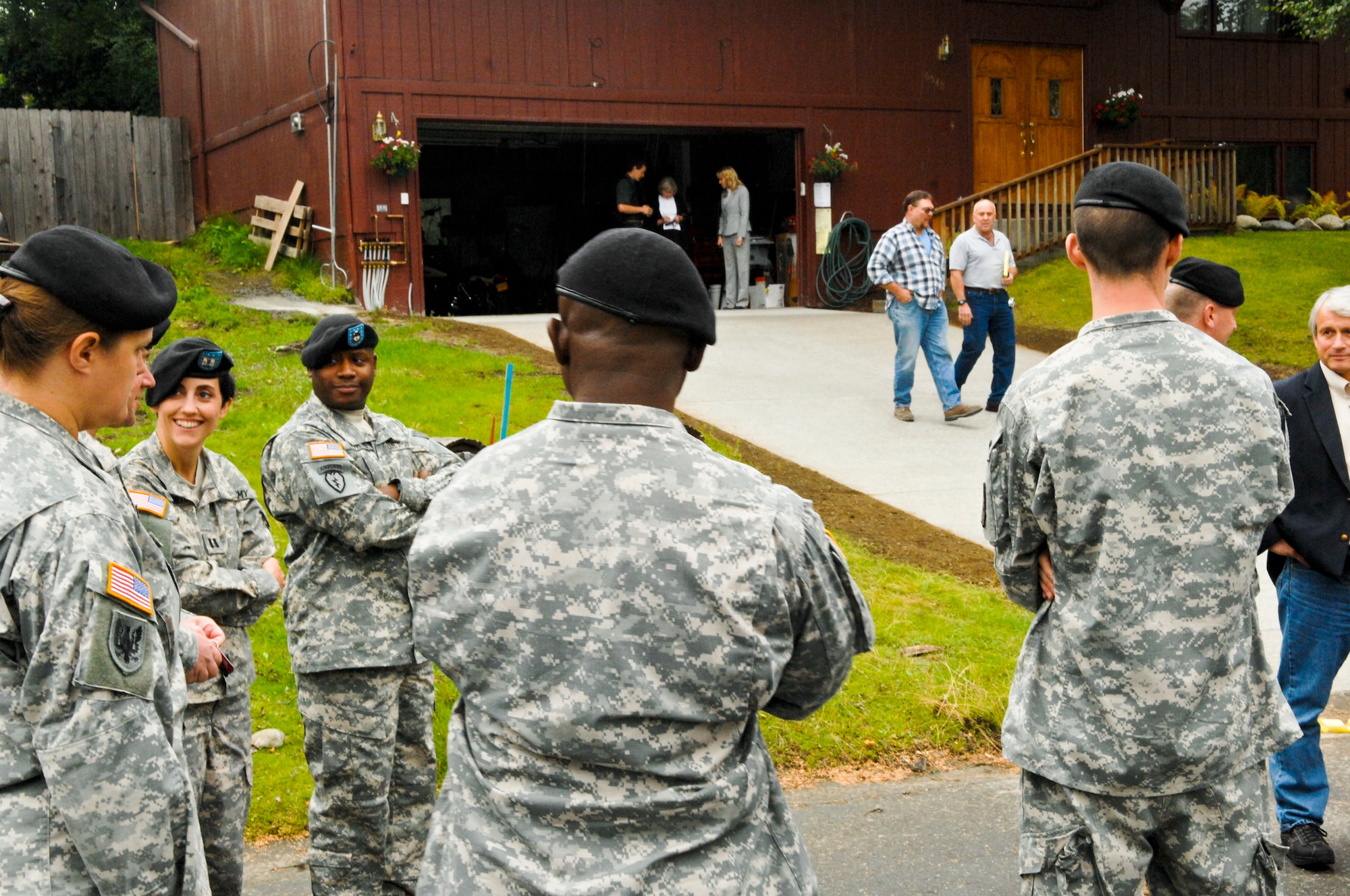 JOINT BASE ELMENDORF-RICHARDSON, Alaska -- Soldiers admire Sgt. 1st Class David Waite newly refurbished house after a ribbon cutting ceremony Aug. 12. Sergeant Waite, is a wounded warrior and recipient of the first Alaskan Operation Opening Doors project, which spent over $40,000 worth of donated supplies and man-hours to improve Sergeant Waite's home to better accomidate his disabilities. (Air Force photo by Airman 1st Class Jack Sanders)