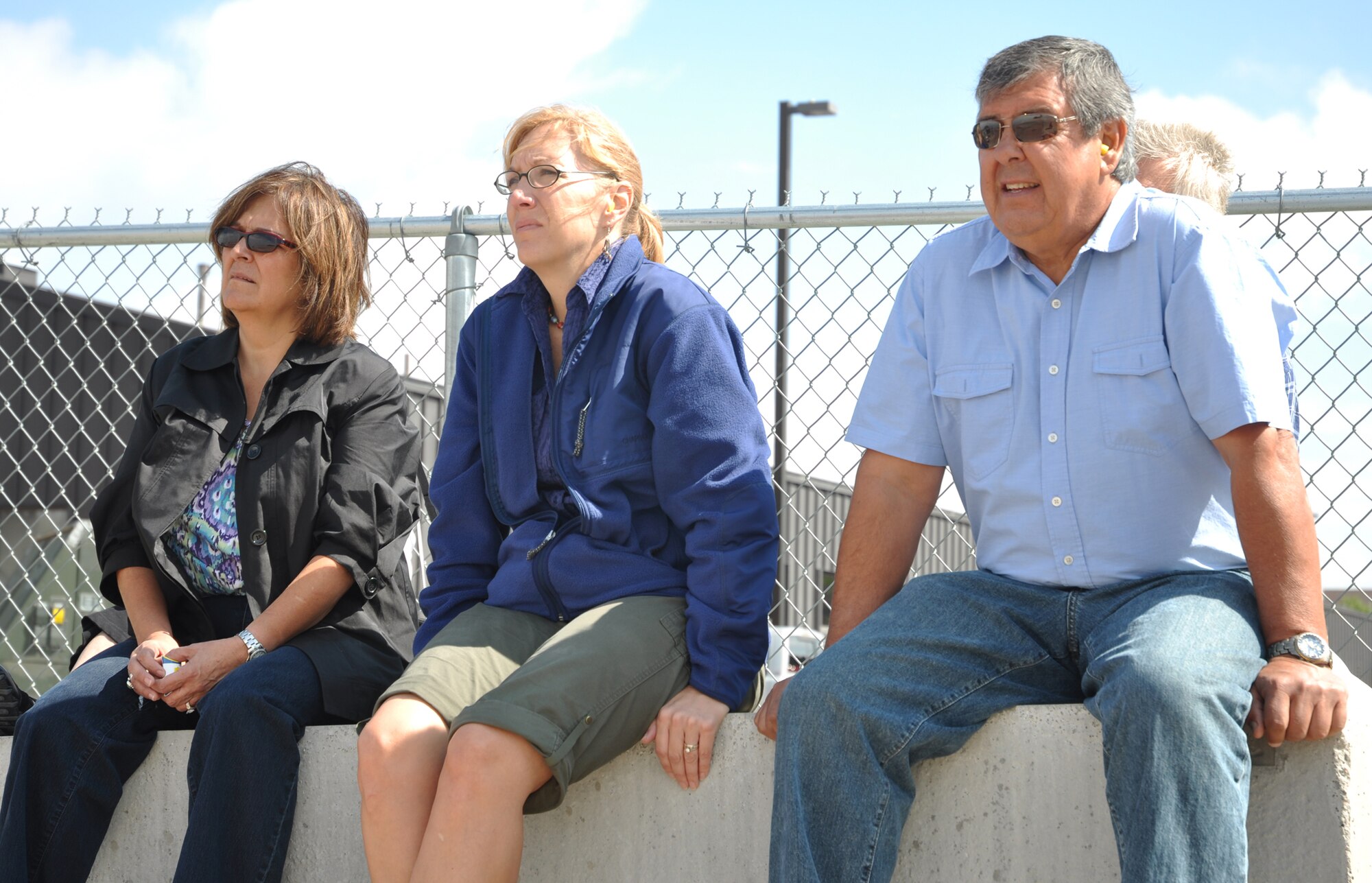 Family members of deploying 52nd Airlift Squadron Airmen watch Aug.16 as a C-130 Hercules taxis to the Peterson Air Force Base runway. The family members were on hand to watch the Active Duty Airmen depart on the transport aircraft for assignments in the Middle East. This is the squadron's first time deploying members in support of U.S. Central Command objectives since its activation in October 2009. The 52nd AS is an active associate unit, and is paired with the Air Force Reserve's 302nd Airlift Wing. (U.S. Air Force photo/Staff Sgt. Stephen J. Collier)