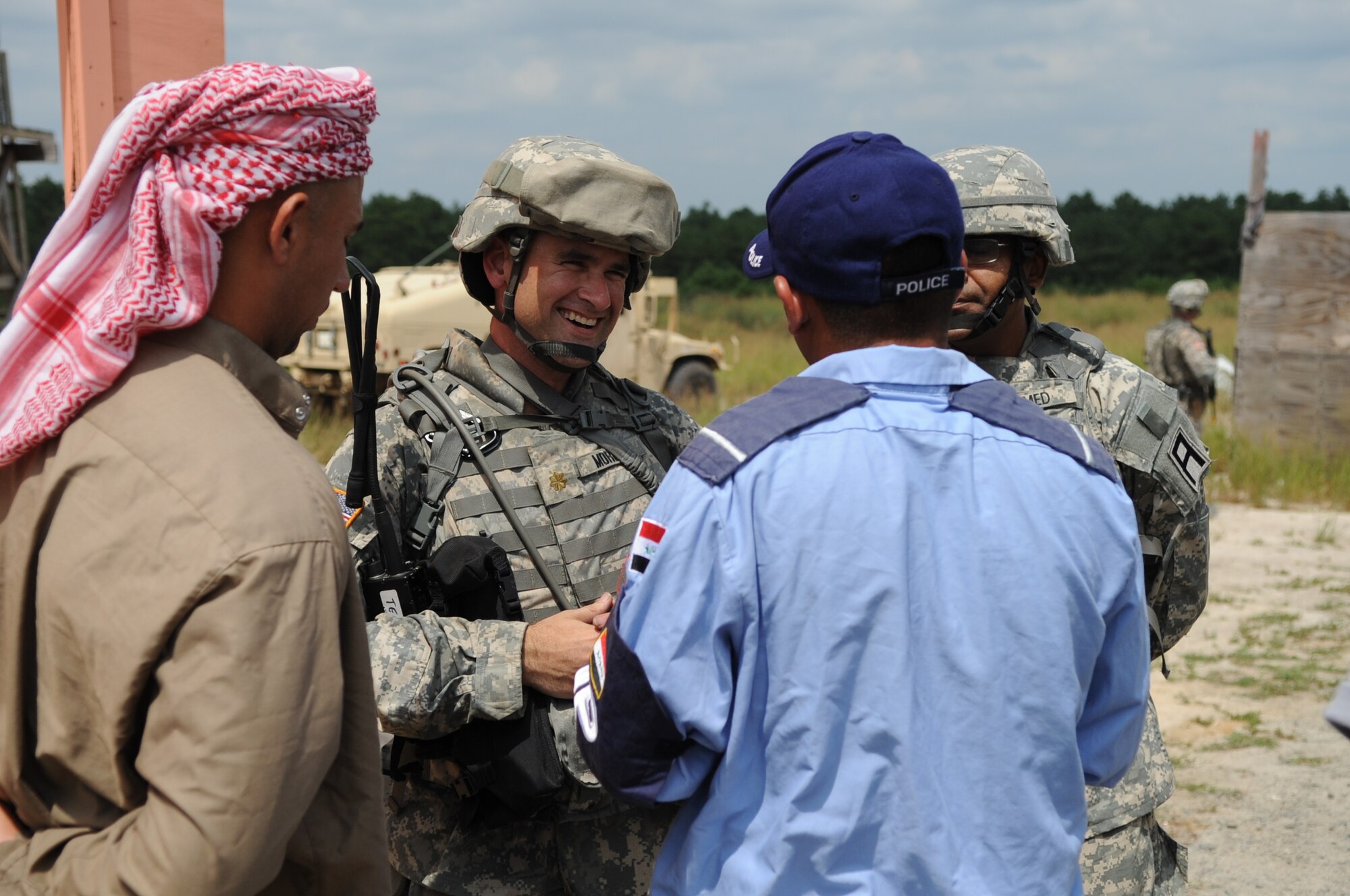 Army Maj. Francisco Morera communicates with a civilian role player during a training mission Aug. 4 at Joint Base McGuire-Dix-Lakehurst. Morera is a member of the 412th Civil Affairs Battalion (Airborne), which is mobilized in support of overseas contingency missions. (U.S. Army photo/Spc. Daniel P. Shook)