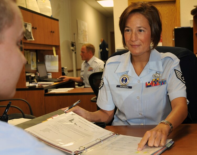 OFFUTT AIR FORCE BASE, Neb. - Staff Sgt. Elizabeth Saunders from the 343rd Recruiting Squadron listens to prospective Air Force recruits in her office in Omaha, Neb. As part of her recruiting duties, Sergeant Saunders gives presentaions to new recruits and their families and explains what the Air Force can offer them. U.S. Air Force photo by Jeff W. Gates.