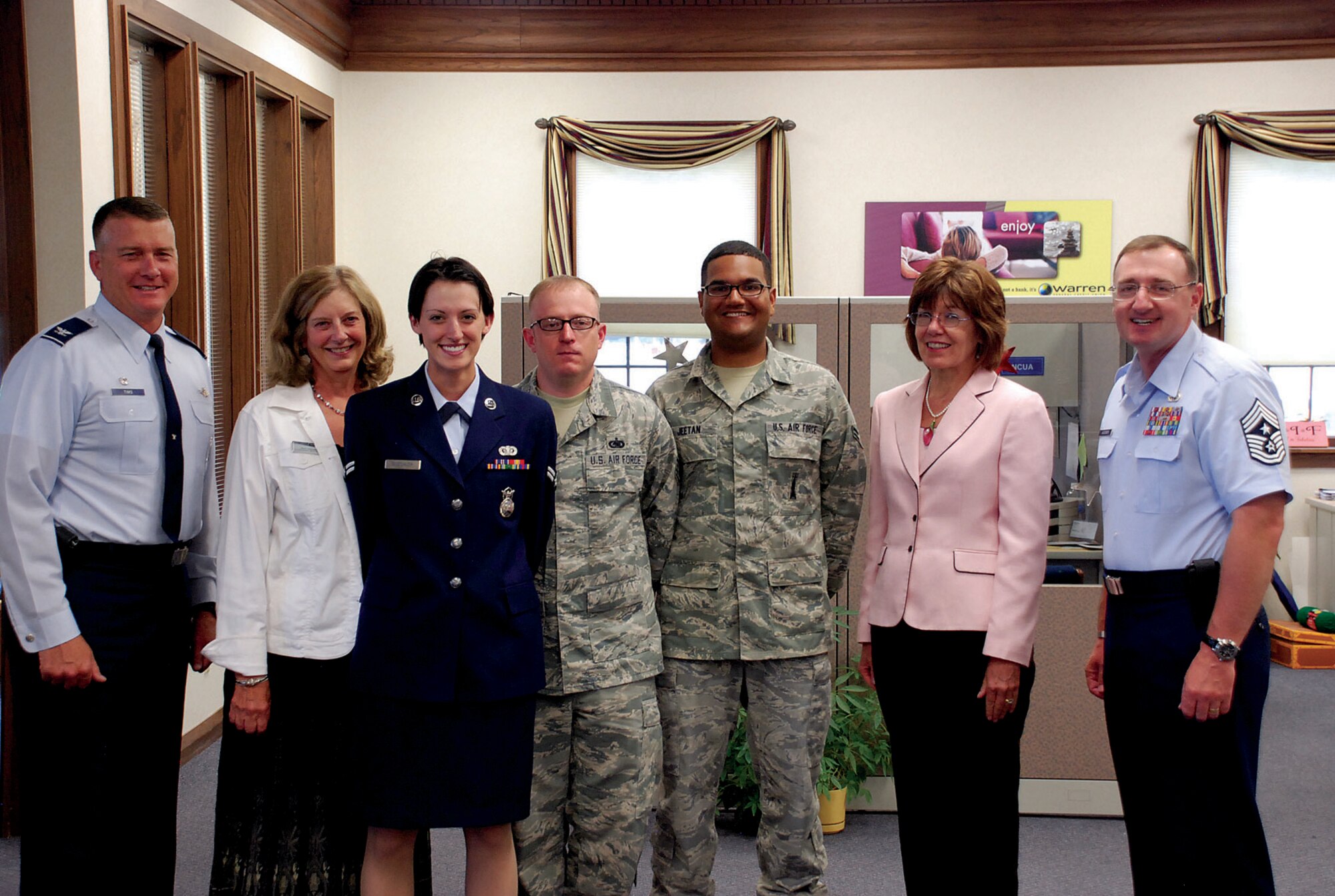 Col. Greg Tims, 90th Missile Wing commander; Chief Master Sgt. Marty Anderson, 90th MW command chief; Mary Thompson, Warren Federal Credit Union branch manager; and Shauna Lacey, Airman & Family Readiness Center; pose with Airman 1st Class Allison Boechler, 790th Missile Security Forces Squadron; Airman 1st Class David Jeetan, 90th Missile Maintenance Squadron; and Staff Sgt. Ryan Bigelow, 90th Logistics Readiness Squadron, Aug. 16 in the Warren FCU. The three were presented checks for their effective financial management plans during the Military Saves Campaign. (U.S. Air Force photo by Staff Sgt. Mike Tryon)