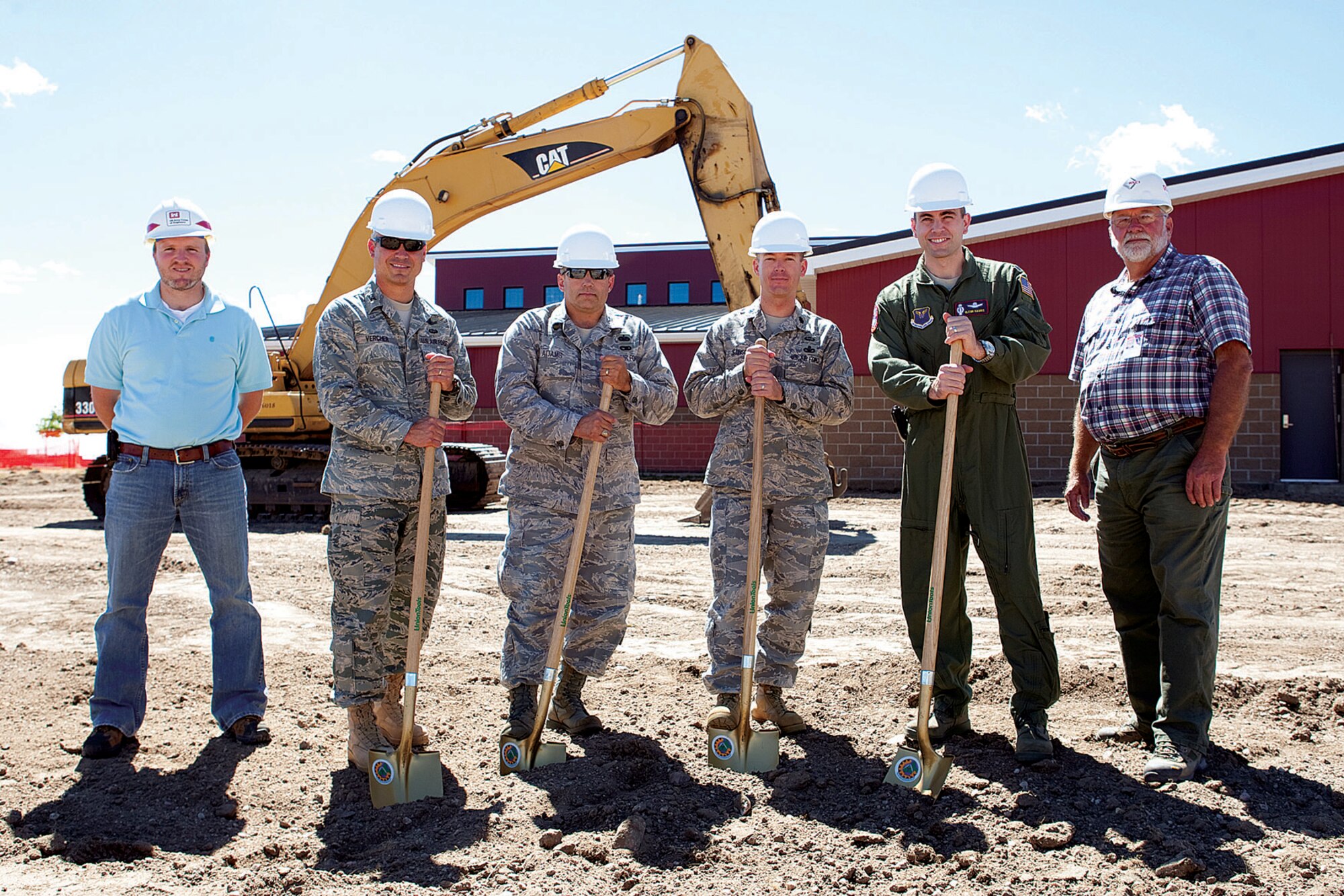 Andy Pakiz, U.S. Army Corps of Engineers; Col. Robert Vercher, 90th Operations Group commander; Col. Don Adams, 90th Maintenance Group commander; Lt. Col. Kiley Stinson, 90th Security Forces Group deputy commander; Lt. Col. Glenn Harris, 90th Operations Support Squadron commander; and Steve Jacobsen, RSCI Corp; break ground on the new addition to the Missile Services Complex on Aug. 11. (U.S. Air Force photo by Jeff Allred)