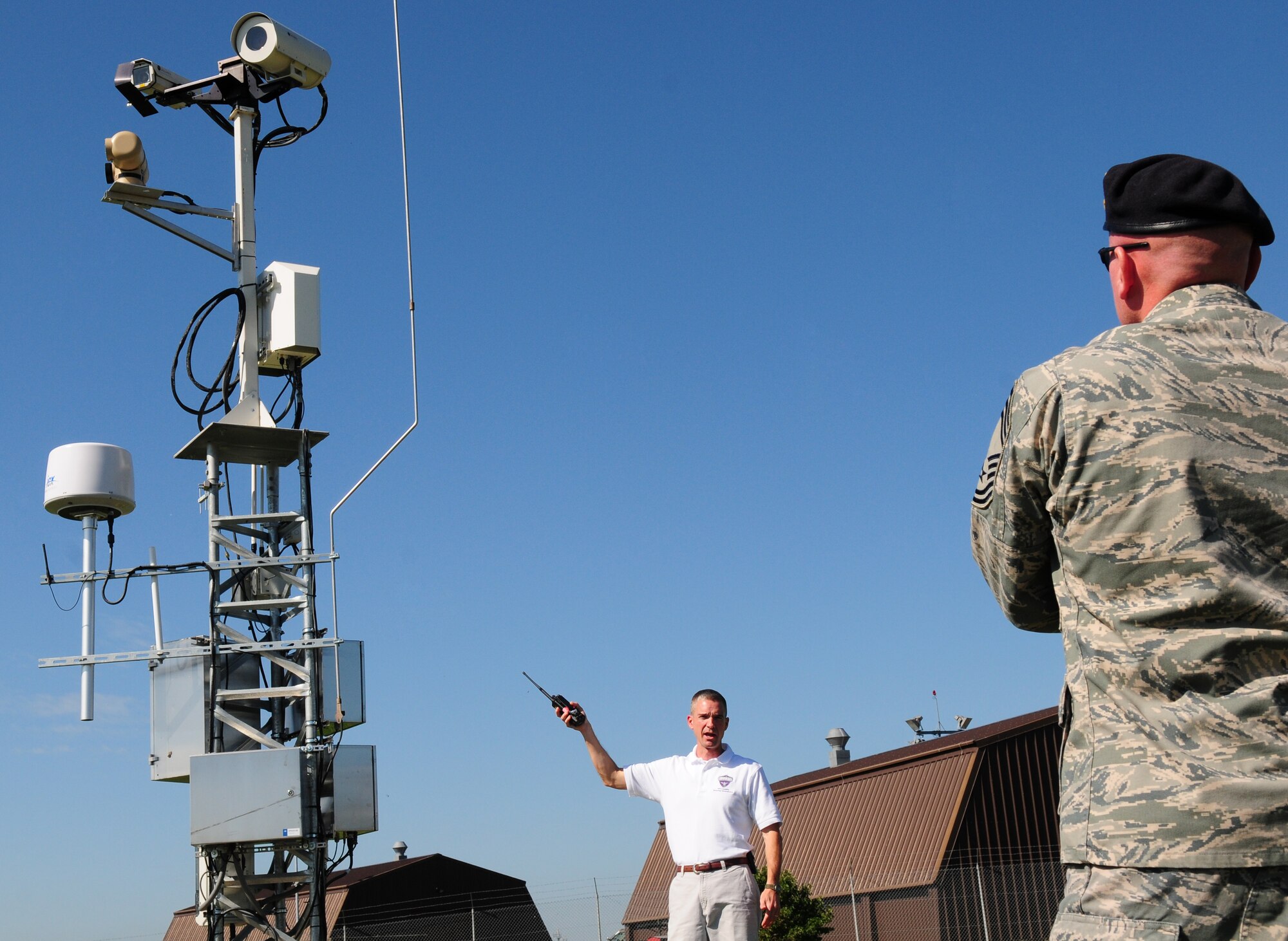 SPANGDAHELM AIR BASE, Germany – David Dykes, Joint Force Protection Advanced Security System team member, provides tower information to Chief Master Sgt. Kevin Peters, U.S. Air Forces in Europe Security Forces Manager, during a site tour of key components of the JFPASS Aug. 20.  The system integrates advanced technology including Smart Car-sized robots, cameras, software and motion sensors with existing technology to increase force protection capabilities. (U.S. Air Force photo/Staff Sgt. Heather M. Norris)