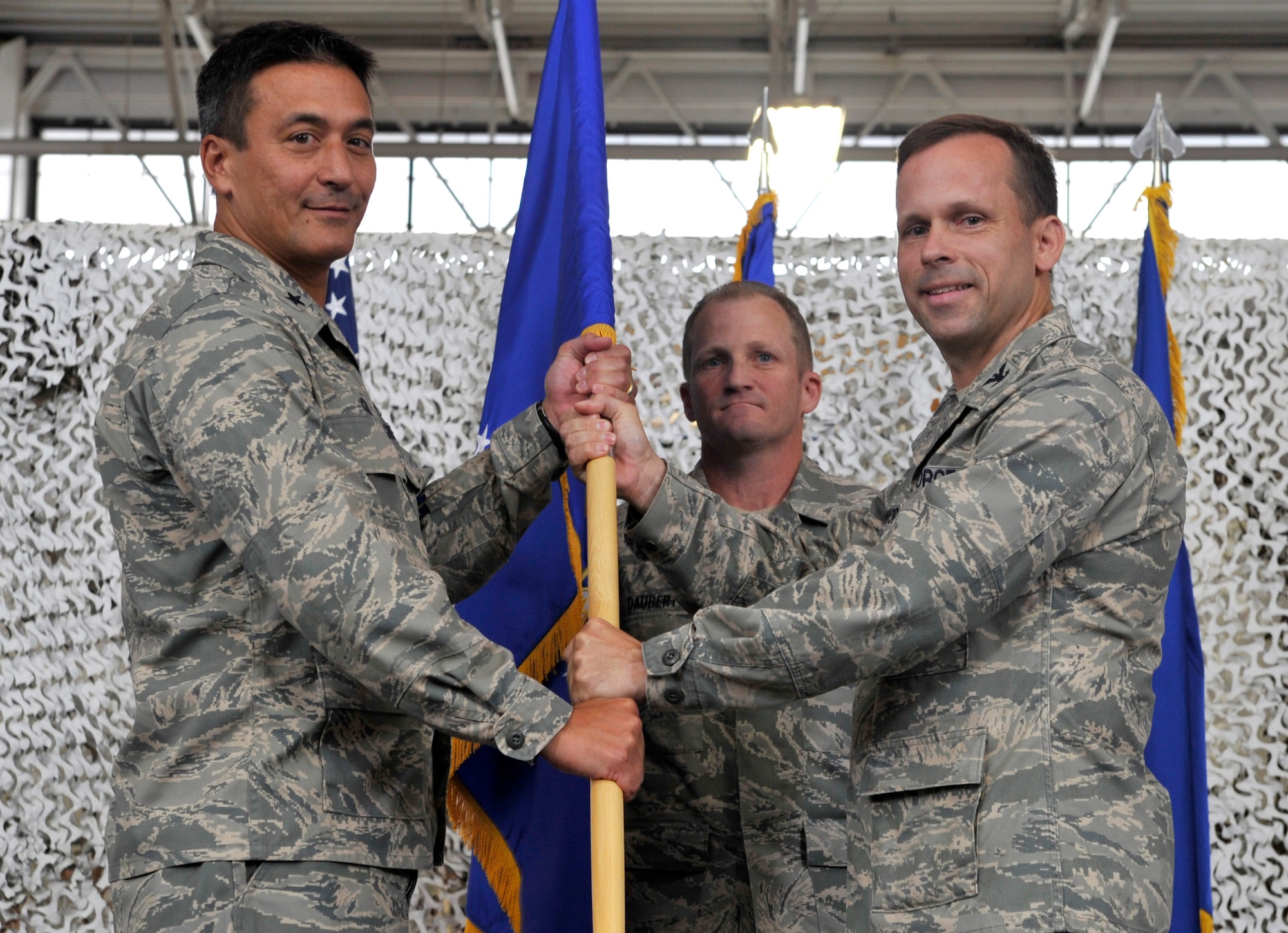 JOINT BASE MCGUIRE-DIX-LAKEHURST, N.J. - Col. Brian O'Connor, 621st Contingency Response Wing commander, relinquishes command of the unit by passing the unit guideon to Brig. Gen. Michael Kim, 21st Expeditionary Mobility Task Force commander, during a change of command ceremony here Aug. 18. Col. Chris Patterson assumed command of the unit which is responsible for training and rapidly deploying personnel to quickly open airfields in remote locations, the 621st CRW extends Air Mobility Command's ability to deploy people and equipment around the globe. (U.S. Air Force photo by Tech. Sgt. Laura K. Deckman)(released)