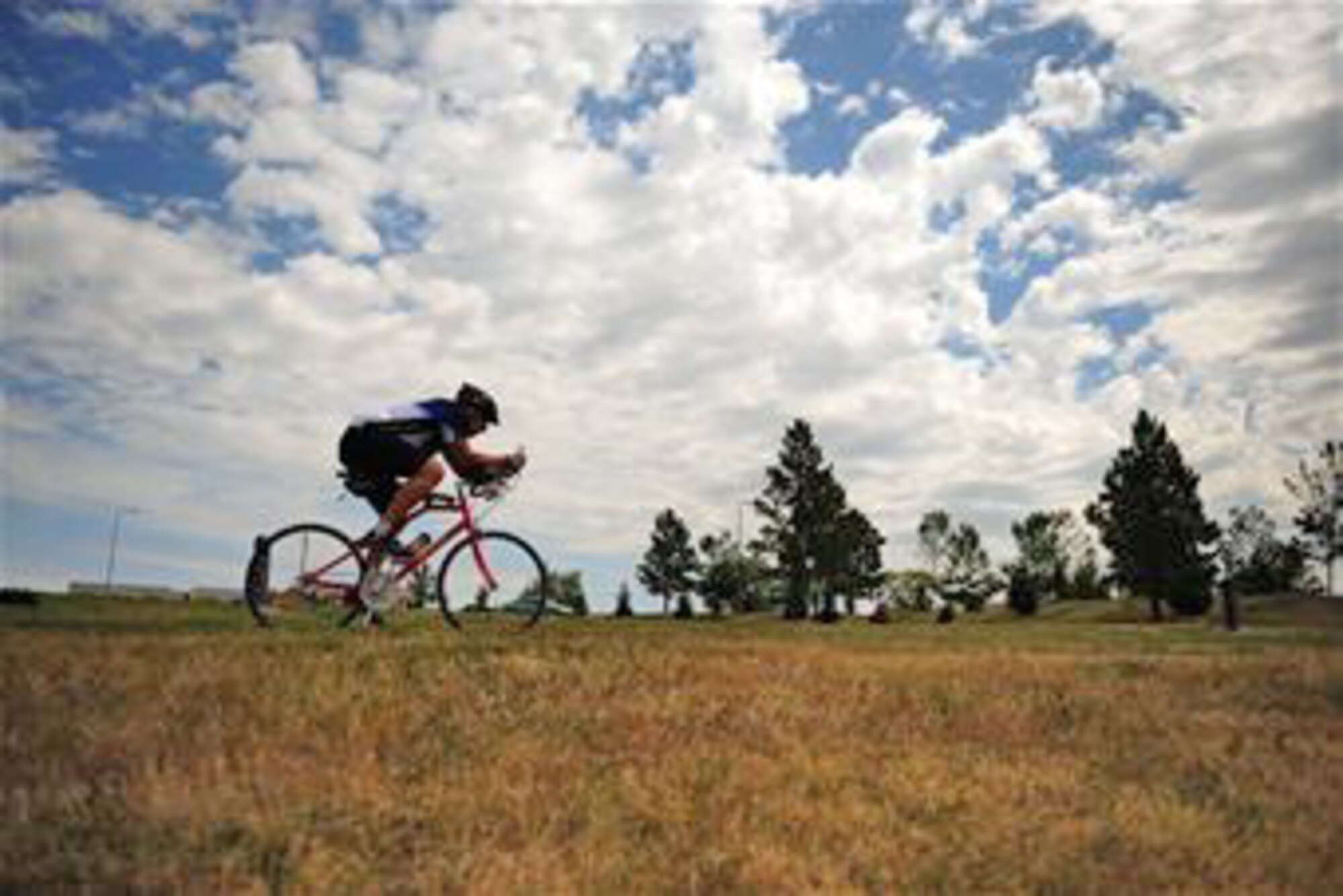 Tech. Sgt. Kory Lindsey rides his bicycle Aug. 16, 2010, at Ellsworth AFB, S.D. Sergeant Lindsey is an air traffic control journeyman with the 28th Operations Support Squadron there. He will participate in a ride to raise money for a cure for multiple sclerosis and his goal is to better the life of a close family member and others who are affected by the disease. (U.S. Air Force photo/Senior Airman Corey Hook)