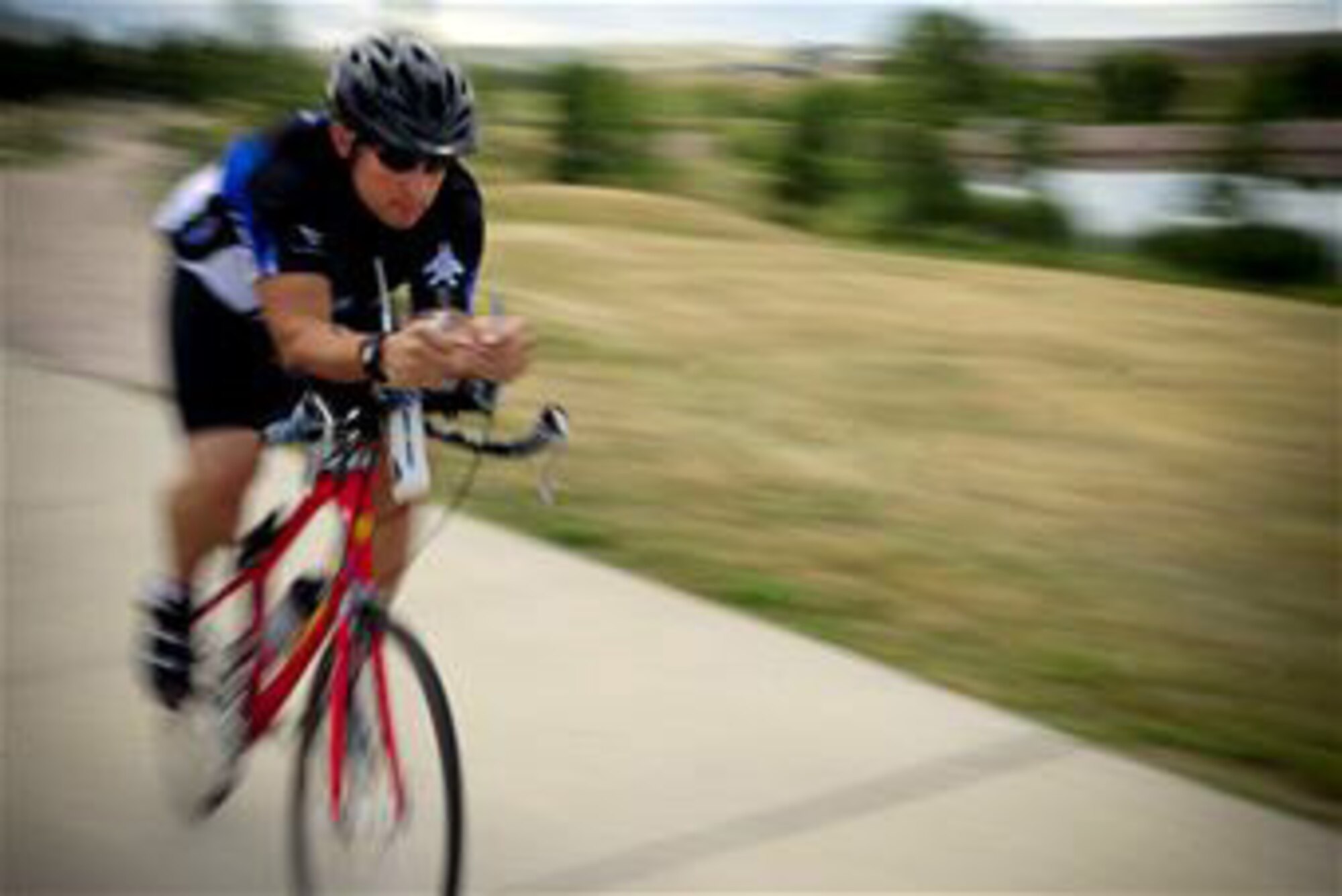 Tech. Sgt. Kory Lindsey rides his bicycle Aug. 16, 2010, at Ellsworth AFB, S.D. Sergeant Lindsey is an air traffic control journeyman with the 28th Operations Support Squadron there. He will participate in a ride to raise money for a cure for multiple sclerosis and his goal is to better the life of a close family member and others who are affected by the disease. (U.S. Air Force photo/Senior Airman Corey Hook)