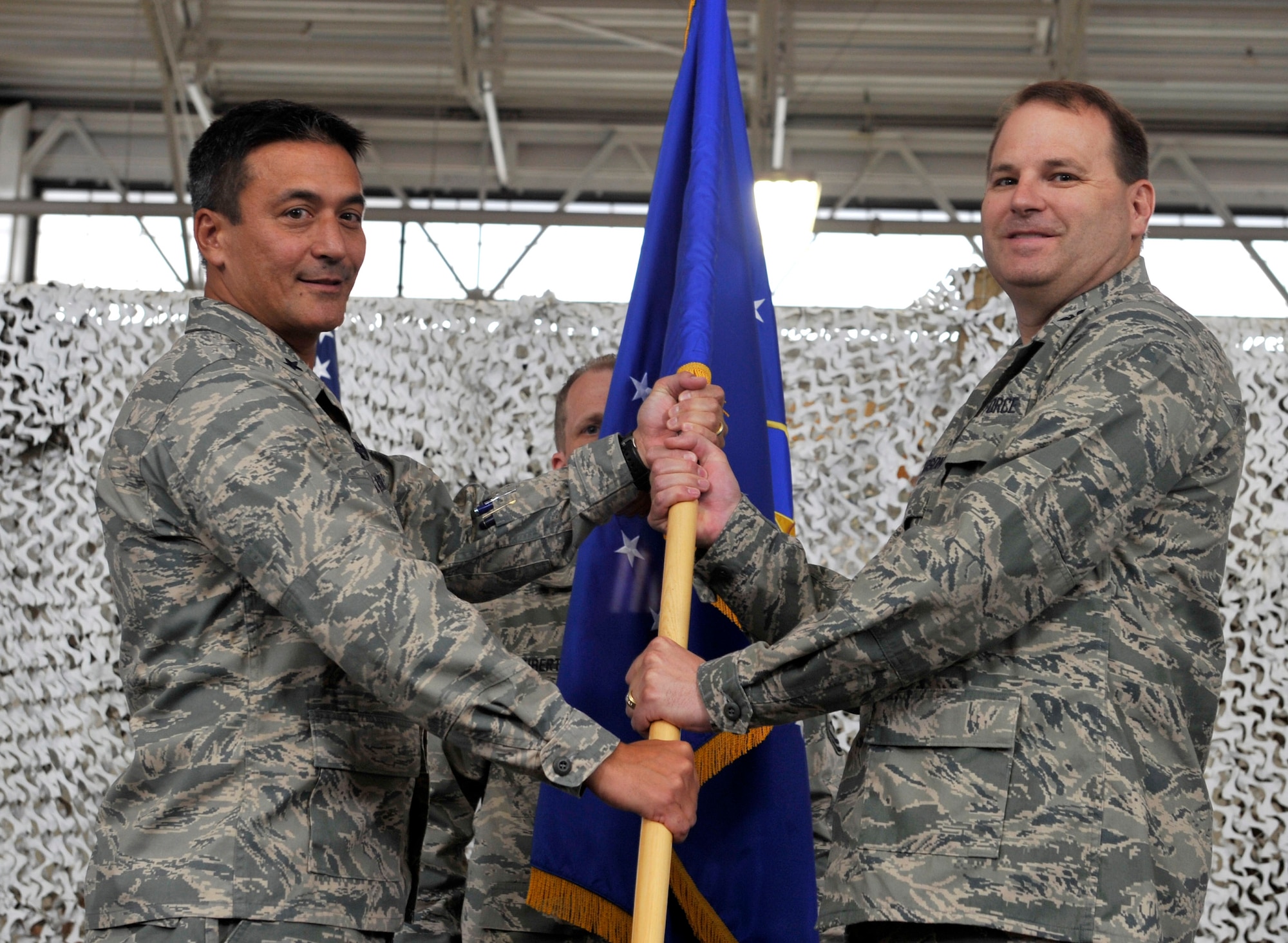 JOINT BASE MCGUIRE-DIX-LAKEHURST, N.J. - Brig. Gen. Michael Kim, 21st Expeditionary Mobility Task Force commander, hands Col. Chris Patterson the unit guideon of the 621st Contingency Response Wing during a change of command ceremony here Aug. 18. Col. Patterson assumed command of the unit which is responsible for training and rapidly deploying personnel to quickly open airfields in remote locations, the 621st CRW extends Air Mobility Command's ability to deploy people and equipment around the globe. (U.S. Air Force photo by Tech. Sgt. Laura K. Deckman)(released)