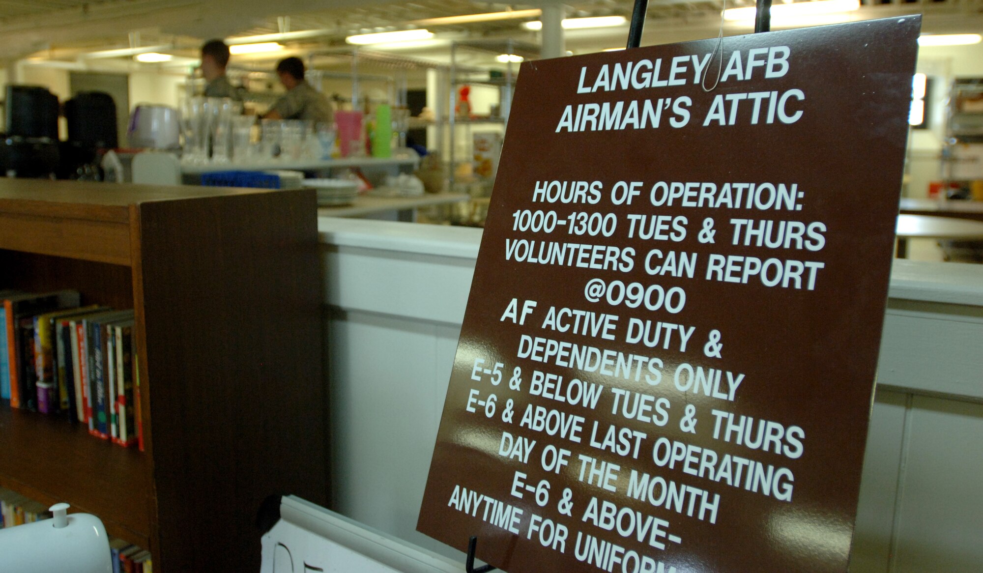 LANGLEY AIR FORCE BASE, Va. -- A sign outlining the Airman’s Attic’s hours of operations and store policies is displayed near the checkout register Aug. 19. Volunteers provided more than 16,800 man hours of renovations over seven days, installing new kitchen tiles, repainting aging walls, re-carpeting and power-washing floors, and removing unneeded walls and glass. (U.S. Air Force photo/Airman 1st Class Jason J. Brown)