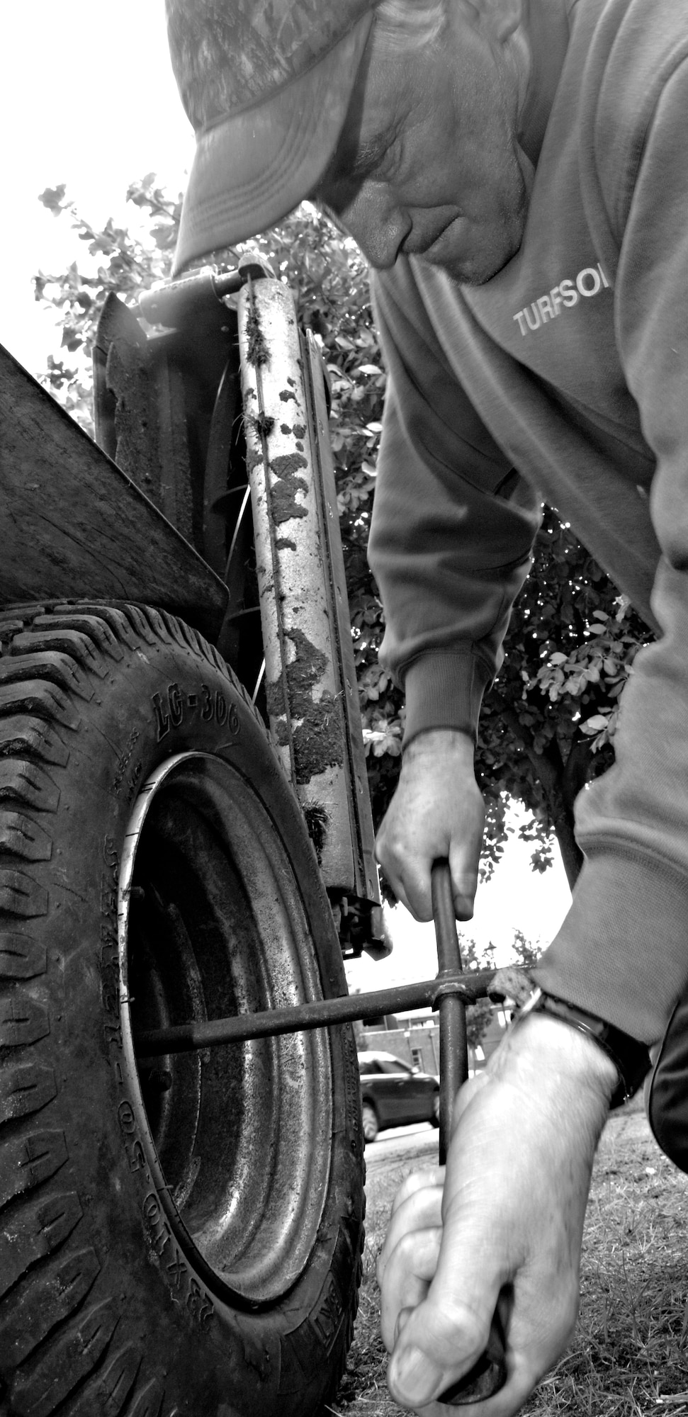 RAF MILDENHALL, England – Glenn Sellers, a local landscaping contractor, changes a tire on his riding mower Aug 20.  Landscapers work round the clock to keep the base looking tidy and well groomed.  (U.S. Air Force photo/ Senior Airman Ethan Morgan)