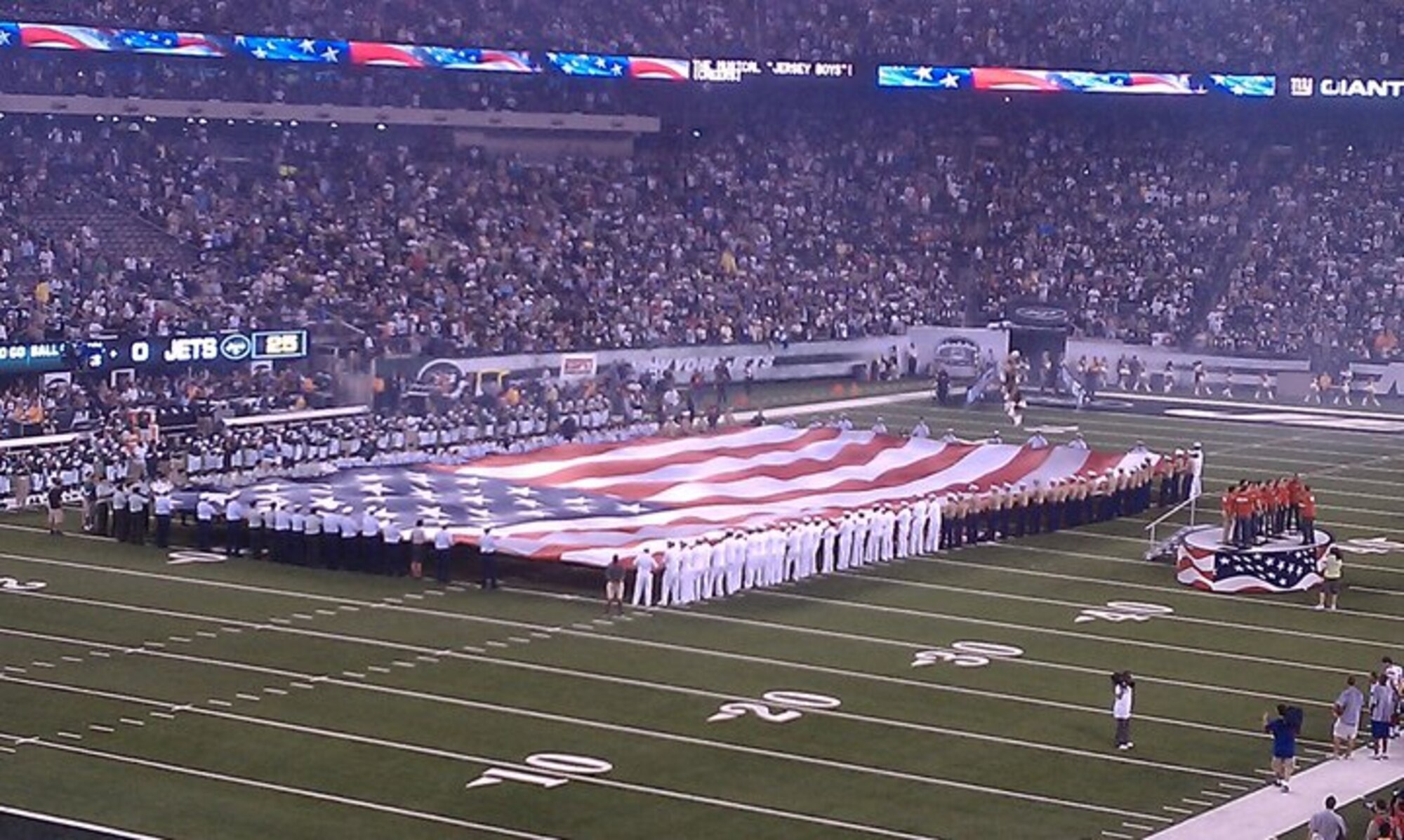Servicemembers from JB MDL assisted members from other military branches unfurl the flag during the N.Y. Giants vs. N.Y. Jets preseason game at the New Meadowlands Stadium Monday as a part of pre-Air Force Week NYC events. Air Force week will be held Aug. 24 through Aug. 29 with all events open to the public. The festivities will include Air Force Bands and performance teams such as Tops In Blue. The Air Force Thunderbirds will perform in an Air Force Week-related event Aug. 25 at the Atlantic City Air Show. (Courtesy photo)