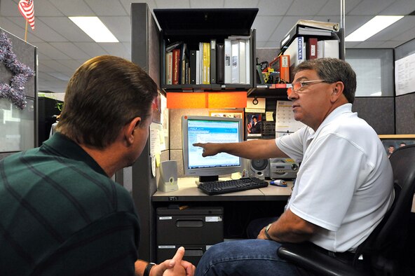 Gary Hull, equipment specialist, and a co-worker train on  Expeditionary Combat Support System software. U.S. Air Force photo by Tommie Horton