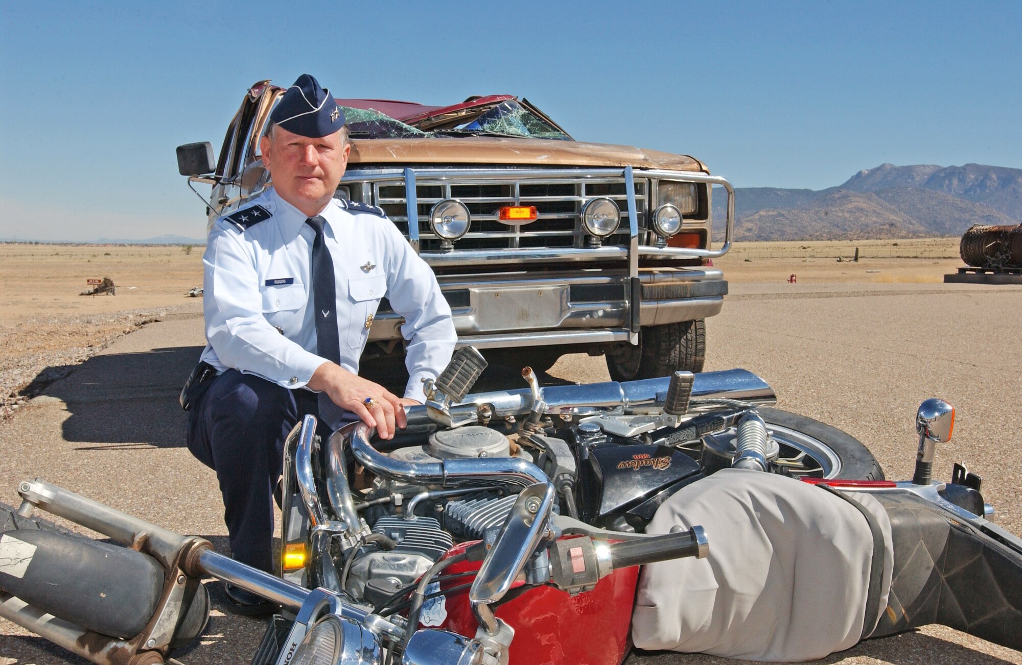 Maj. Gen. Frederick Roggero, Air Force chief of safety, kneels near the aftermath of a motor vehicle accident.  One of the Air Force’s top safety priorities is to reduce motor vehicle mishaps.  Courtesy Photo