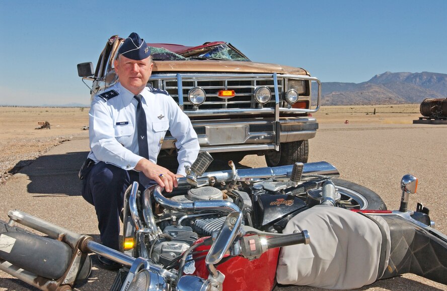 Maj. Gen. Frederick Roggero, Air Force chief of safety, kneels near the aftermath of a motor vehicle accident.  One of the Air Force’s top safety priorities is to reduce motor vehicle mishaps.  Courtesy Photo
