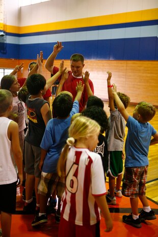 Lance Cpl. Christopher Lorio asks for Pac-Man volunteers during the final day of a sports camp put on by Marine Wing Support Squadron 171 and Marine Corps Community Services at the IronWorks Gym here Aug. 20.